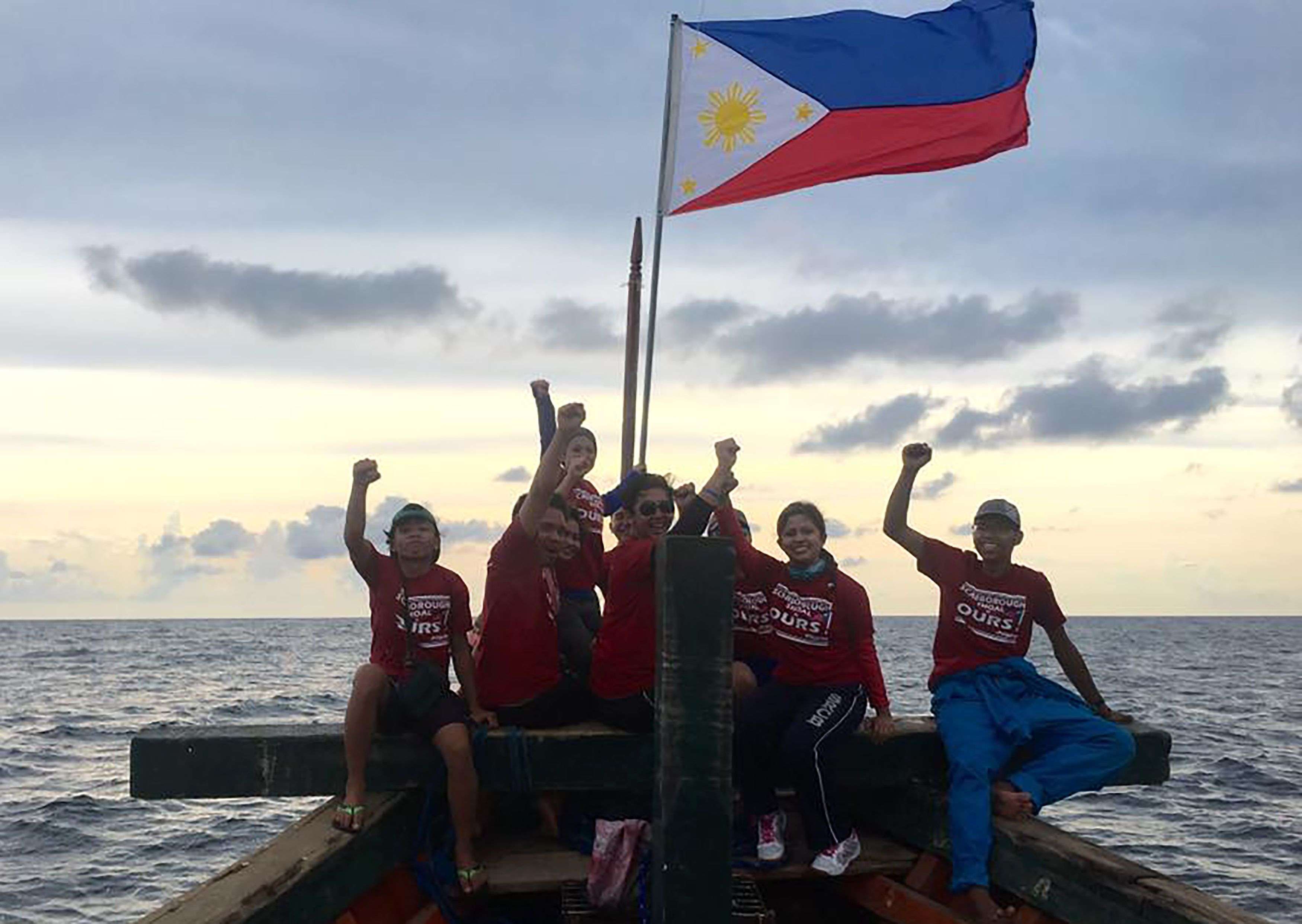 Filipino activists pose for a photo at the Chinese-controlled Scarborough Shoal in the South China Sea. Photo: AFP