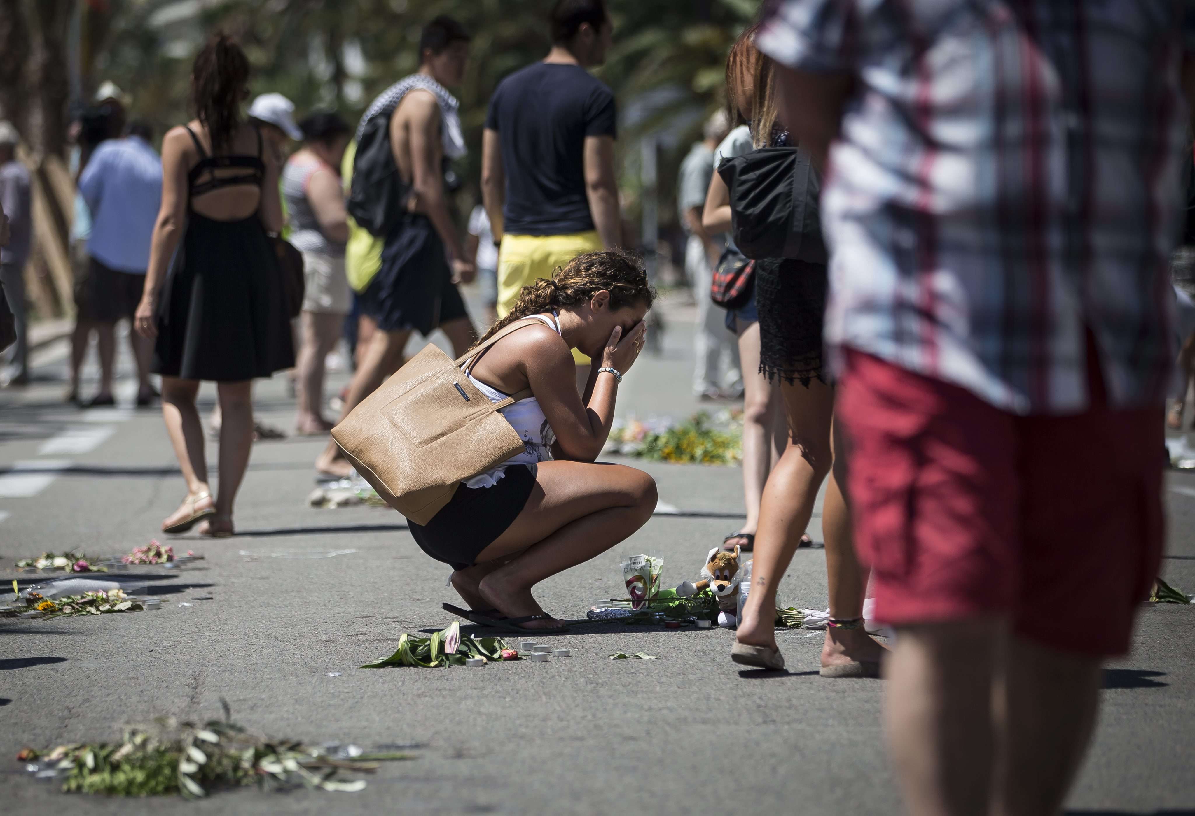 A woman mourns on the Promenade des Anglais, scene of the most recent terrorist atrocity in France. Photo: EPA