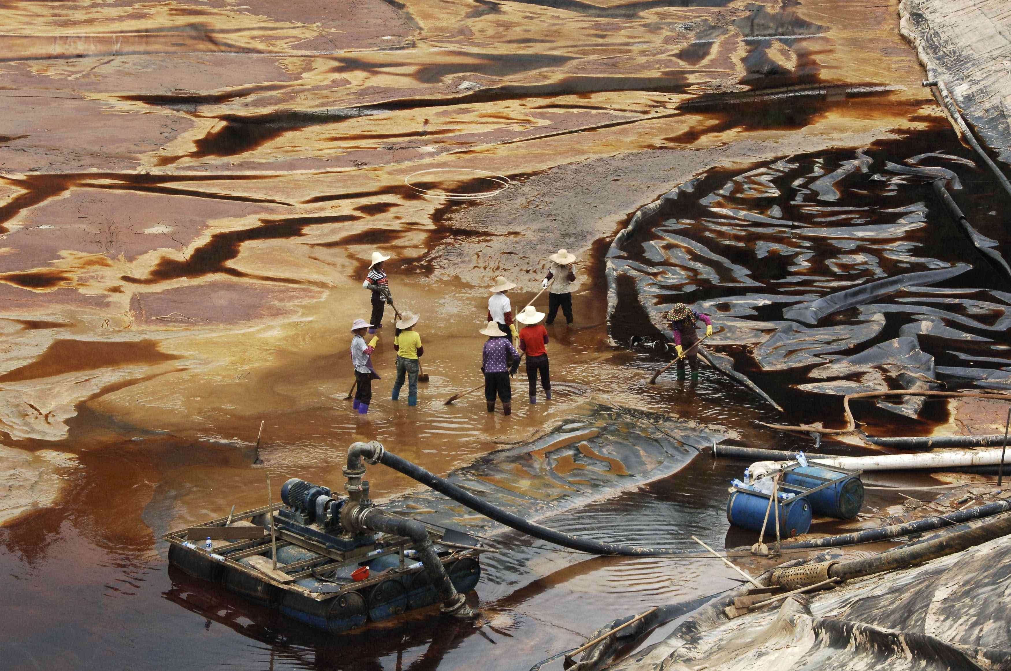 Labourers work to drain sewage water from a leaked sewage tank at a copper mine in Shanghang, Fujian province. China’s mining industry is notorious for its environmental damage, and the pollution is usually irreversible. Photo: Reuters