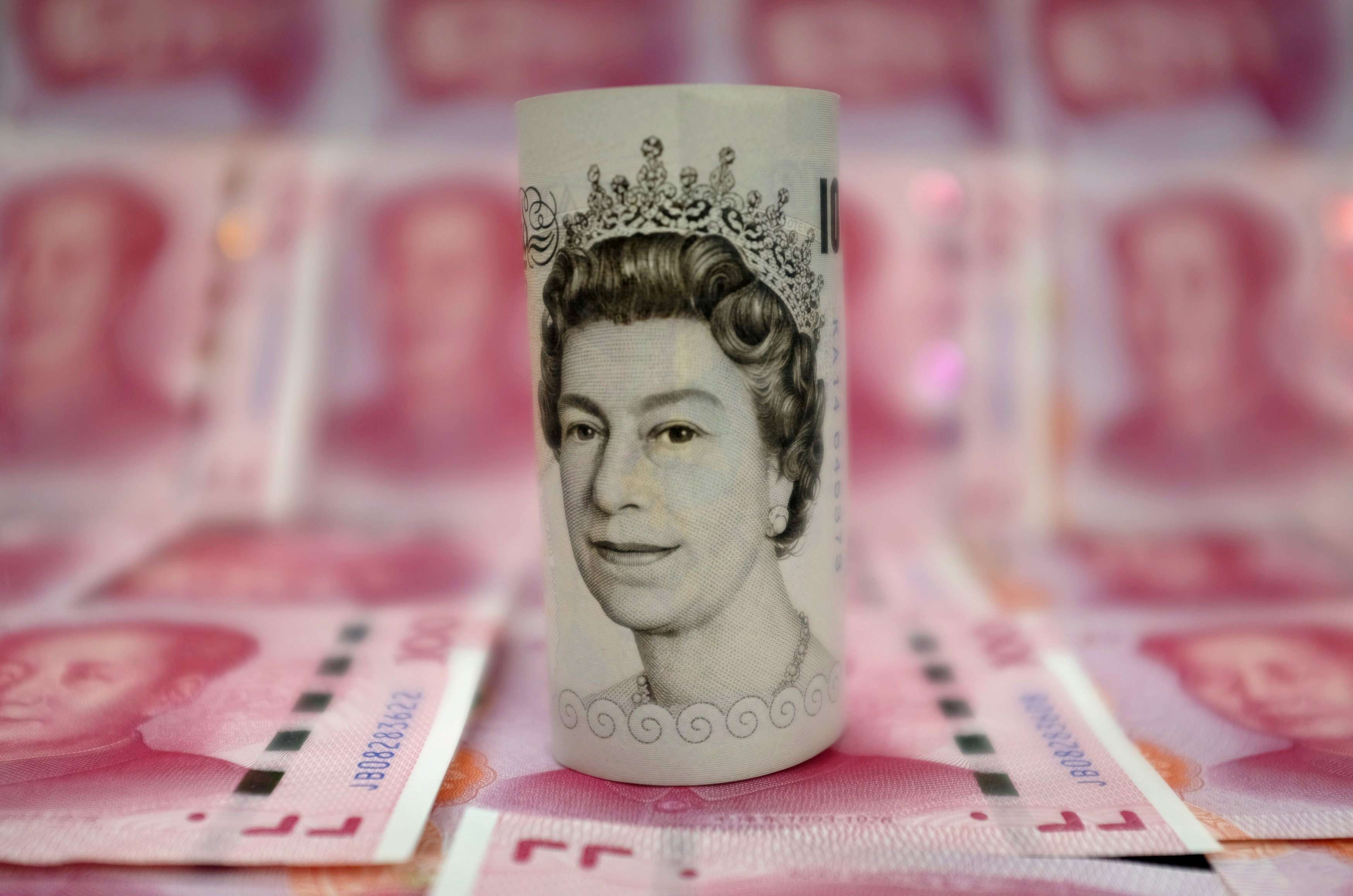 A British 10-pound banknote amid Chinese 100-yuan banknotes. Photo: Reuters