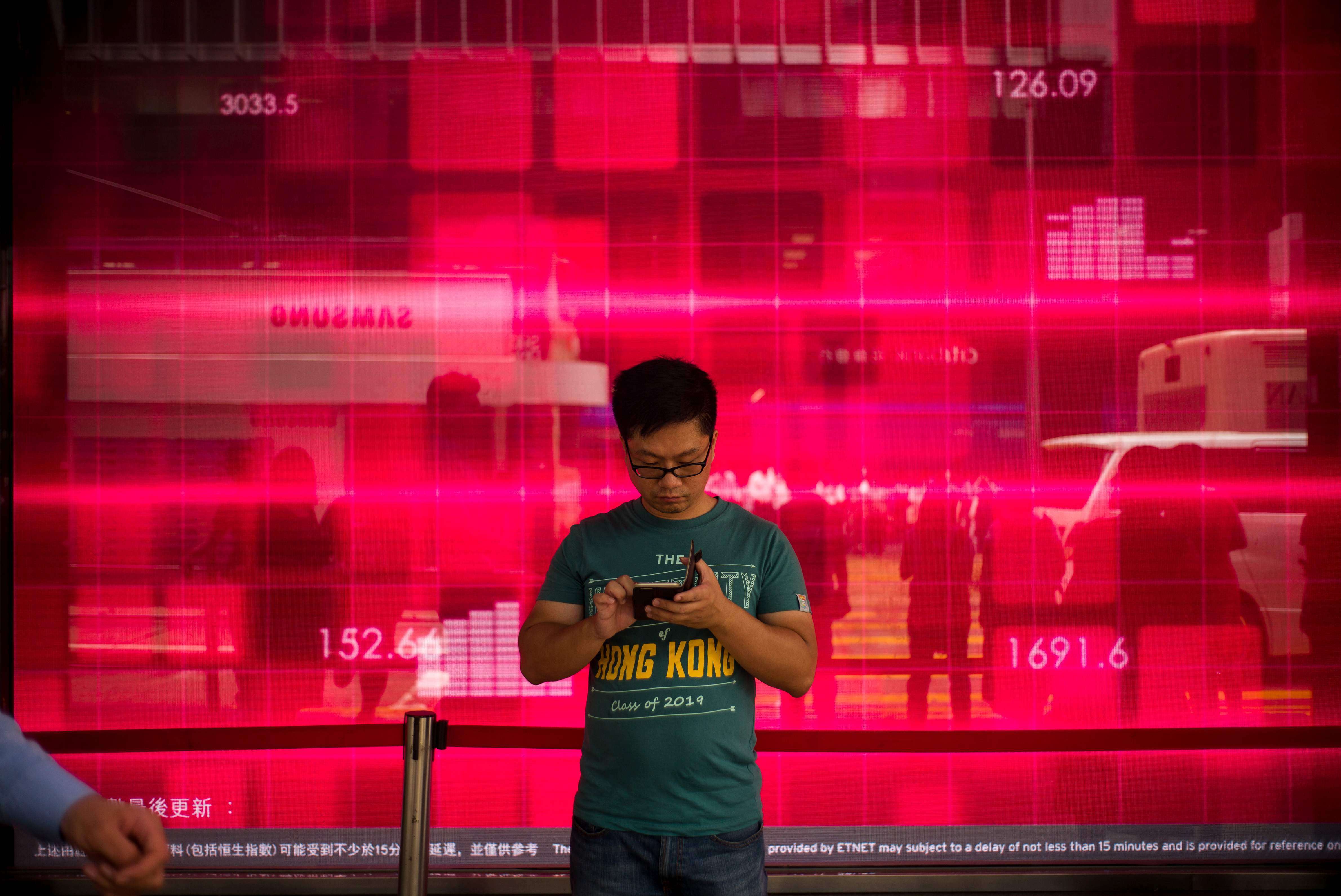 A man uses his mobile phone in Central, Hong Kong. Photo: AFP
