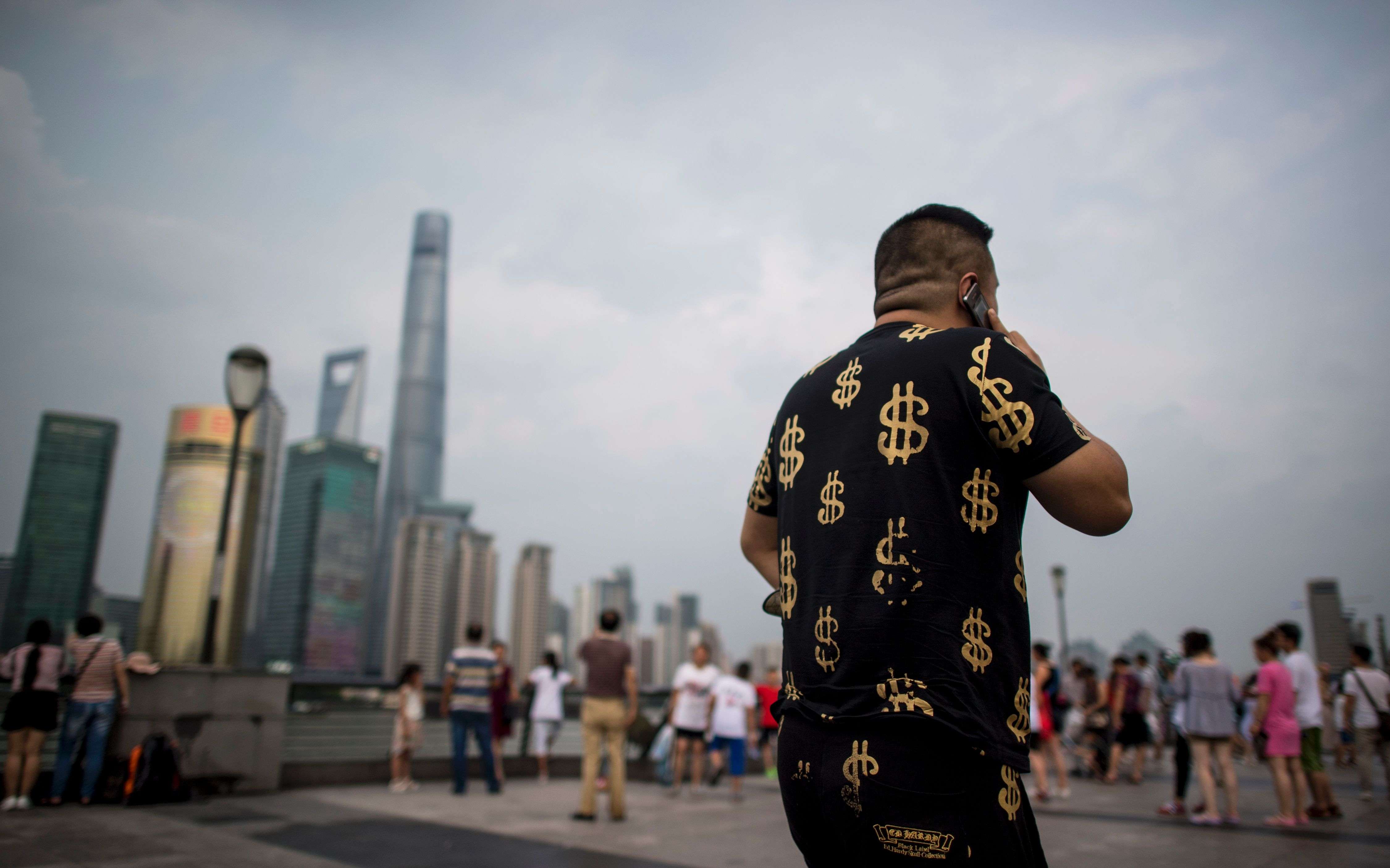 A man walks down the Bund overlooking the financial district of Pudong in Shanghai. Chinese workers have grown accustomed to rising prosperity. Photo: AFP