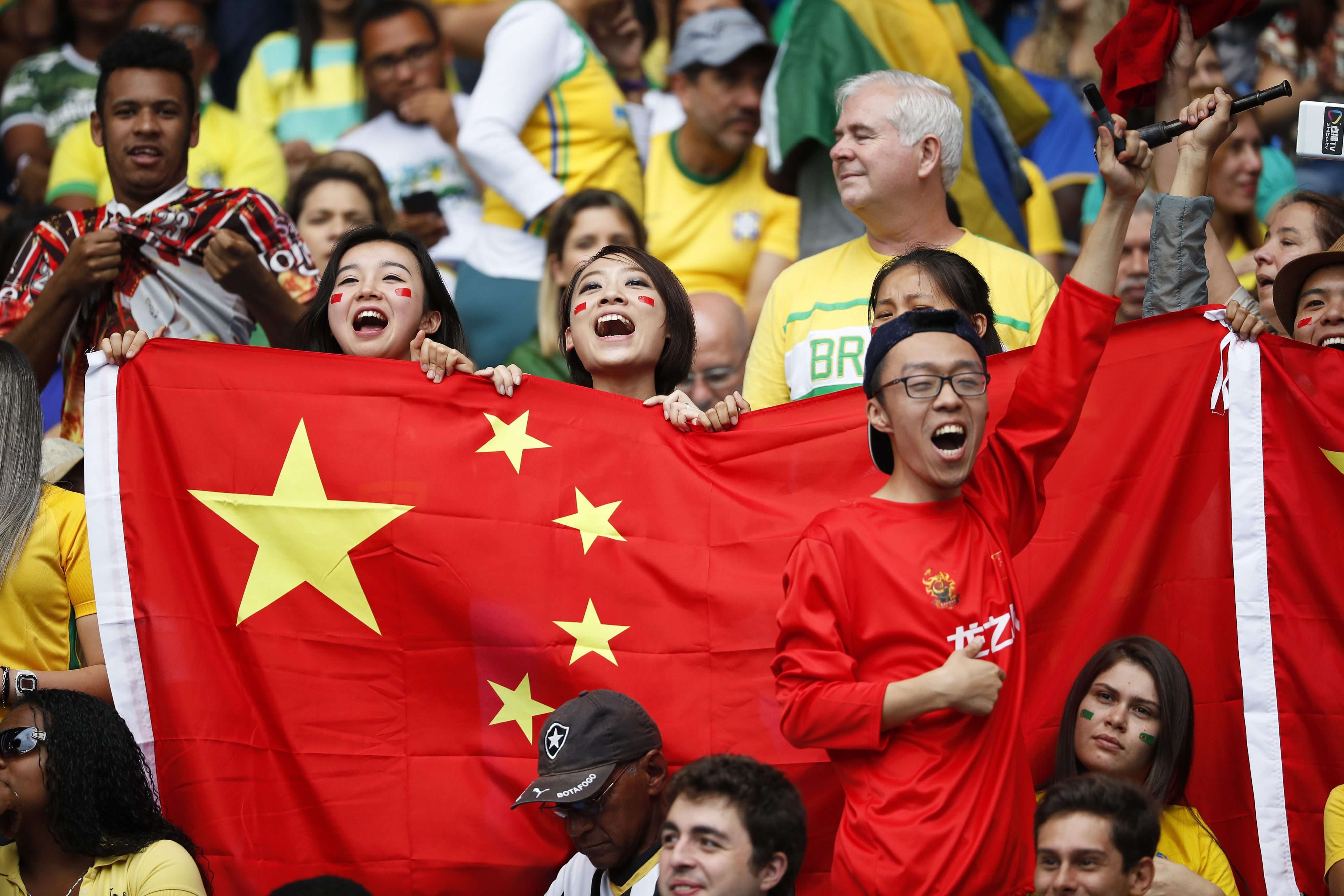 Chinese fans cheer on their team during the women’s first-round match between Brazil and China at the Rio Olympics. Pushed by President Xi Jinping, the Chinese government plans to turn the country into a soccer powerhouse by 2050. Photo: EPA