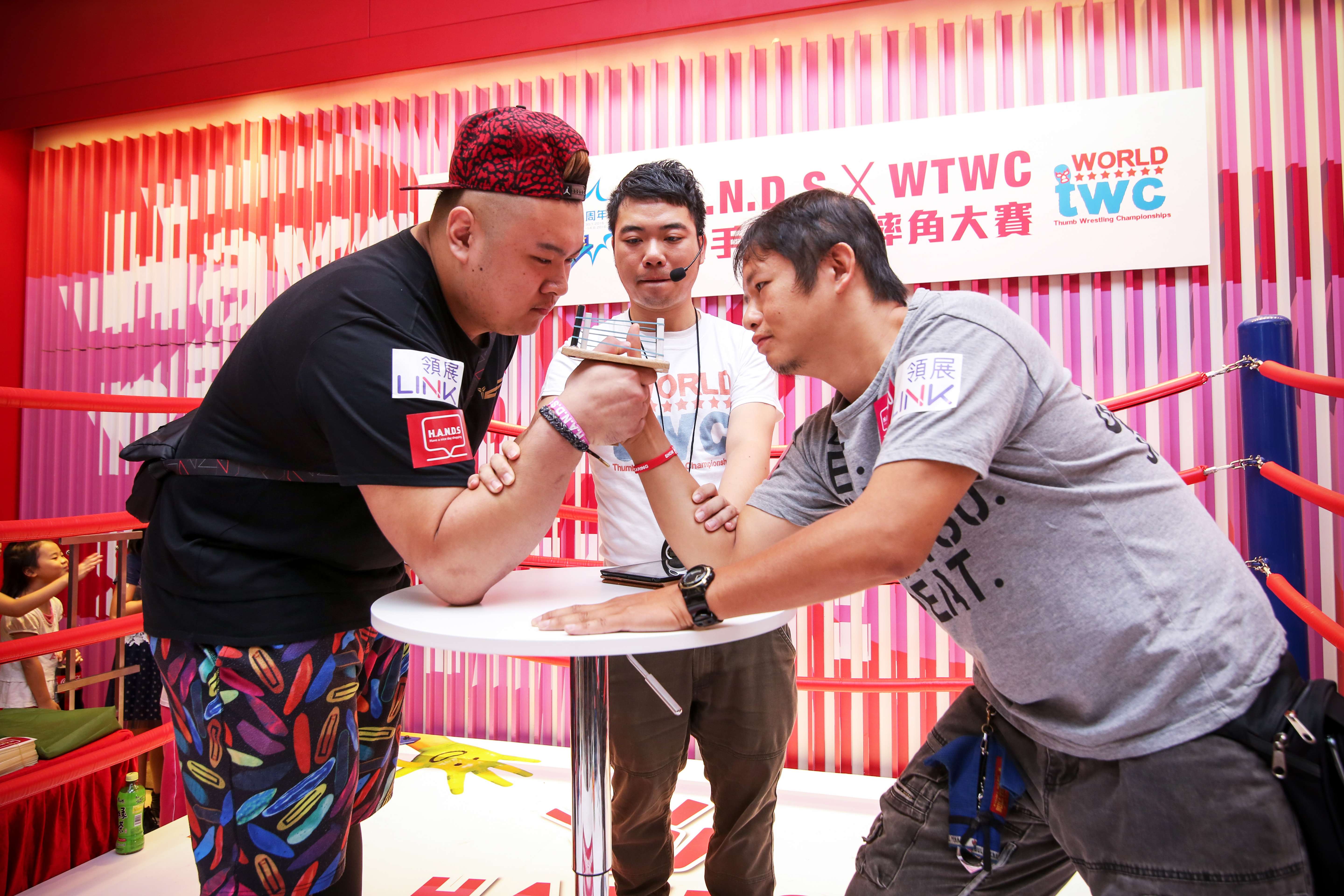 Local participants battling in the semi-finals of the World Thumb Wrestling Championships in Hong Kong. Photo: SCMP Pictures