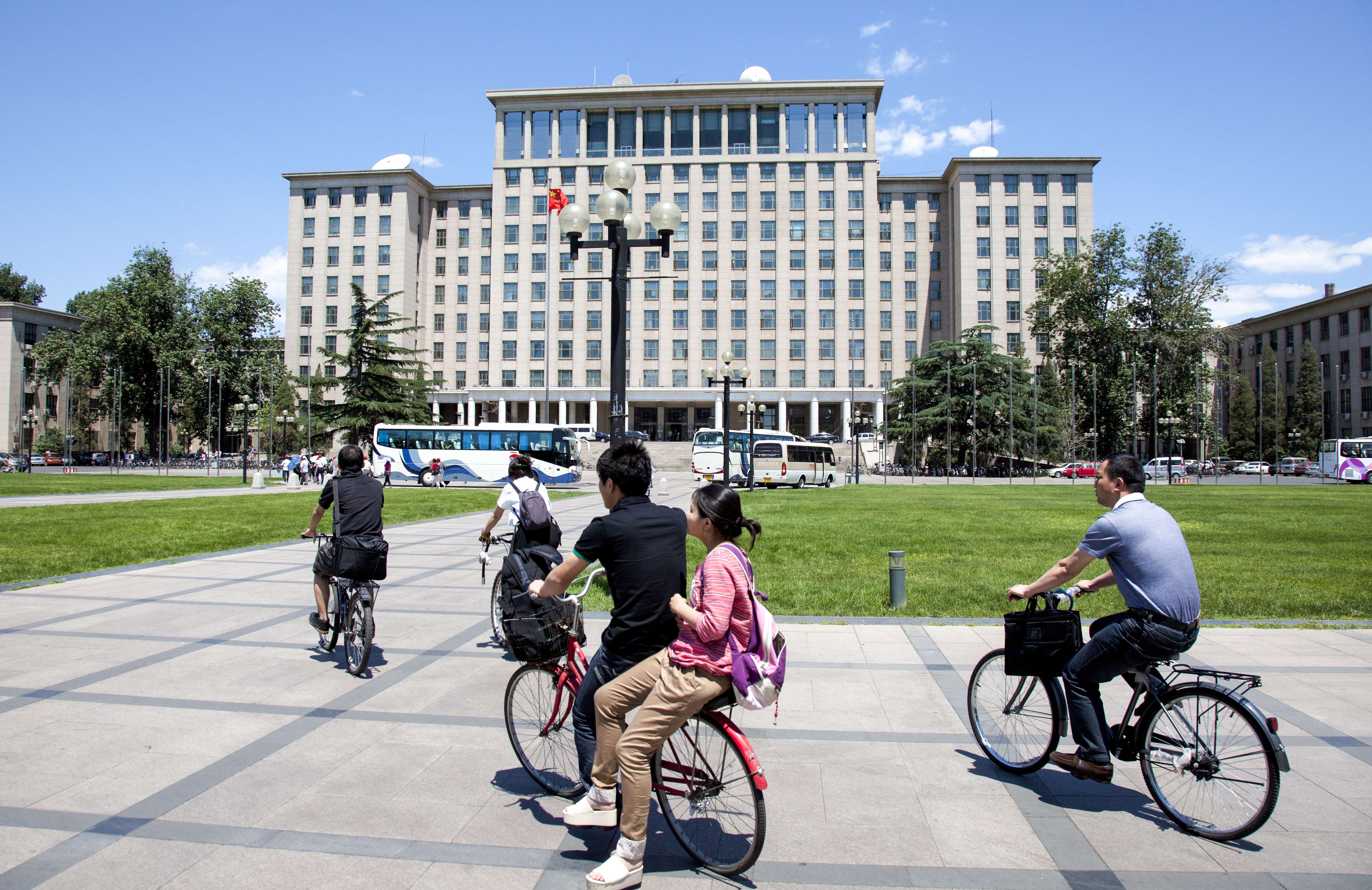 Students cycle past the central main building on campus at Tsinghua University in Beijing. Photo: SCMP Pictures