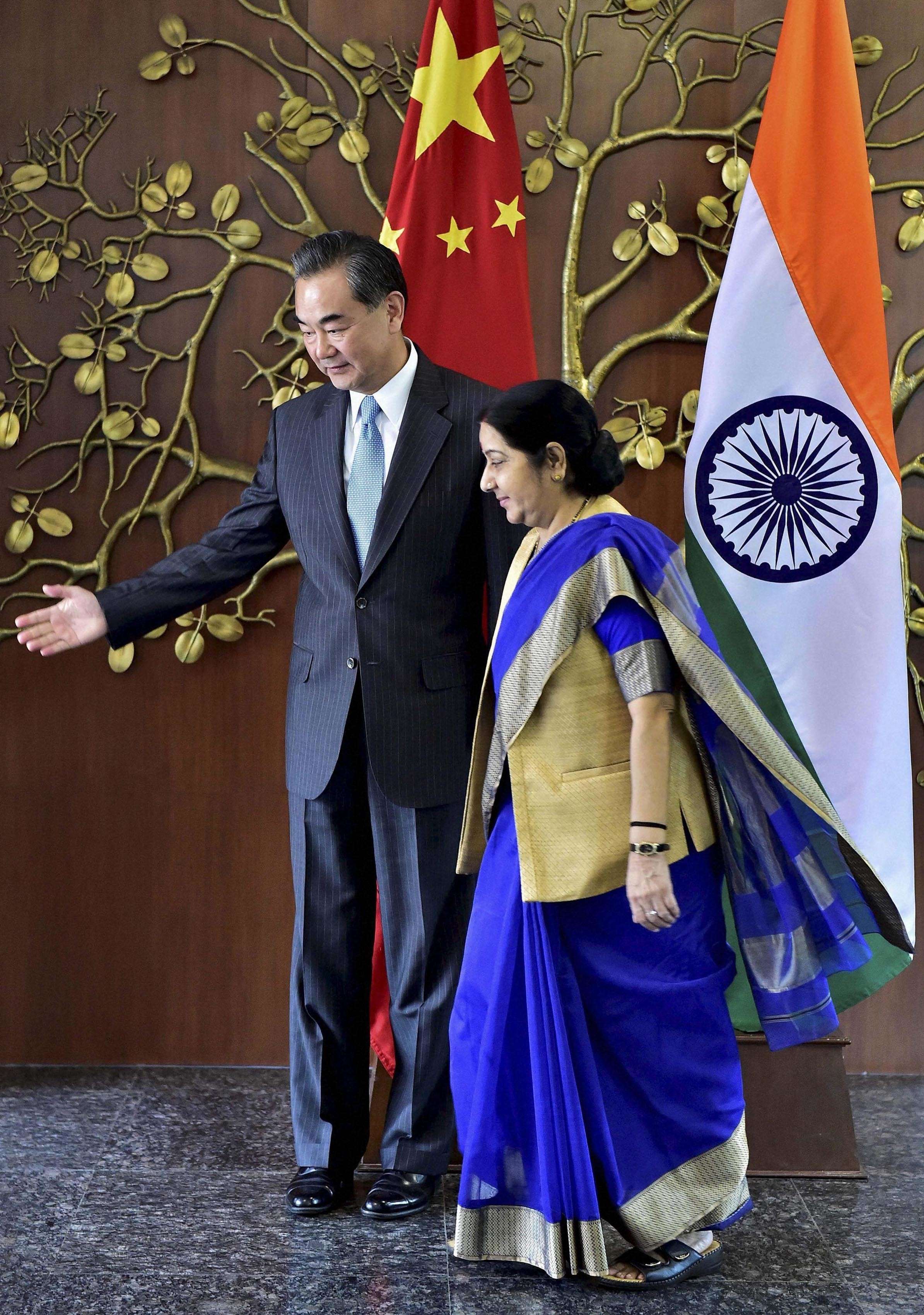 Visiting Foreign Minister Wang Yi and Indian External Affairs Minister Sushma Swaraj arrive for a meeting in New Delhi, India, on August 13. Photo: AP