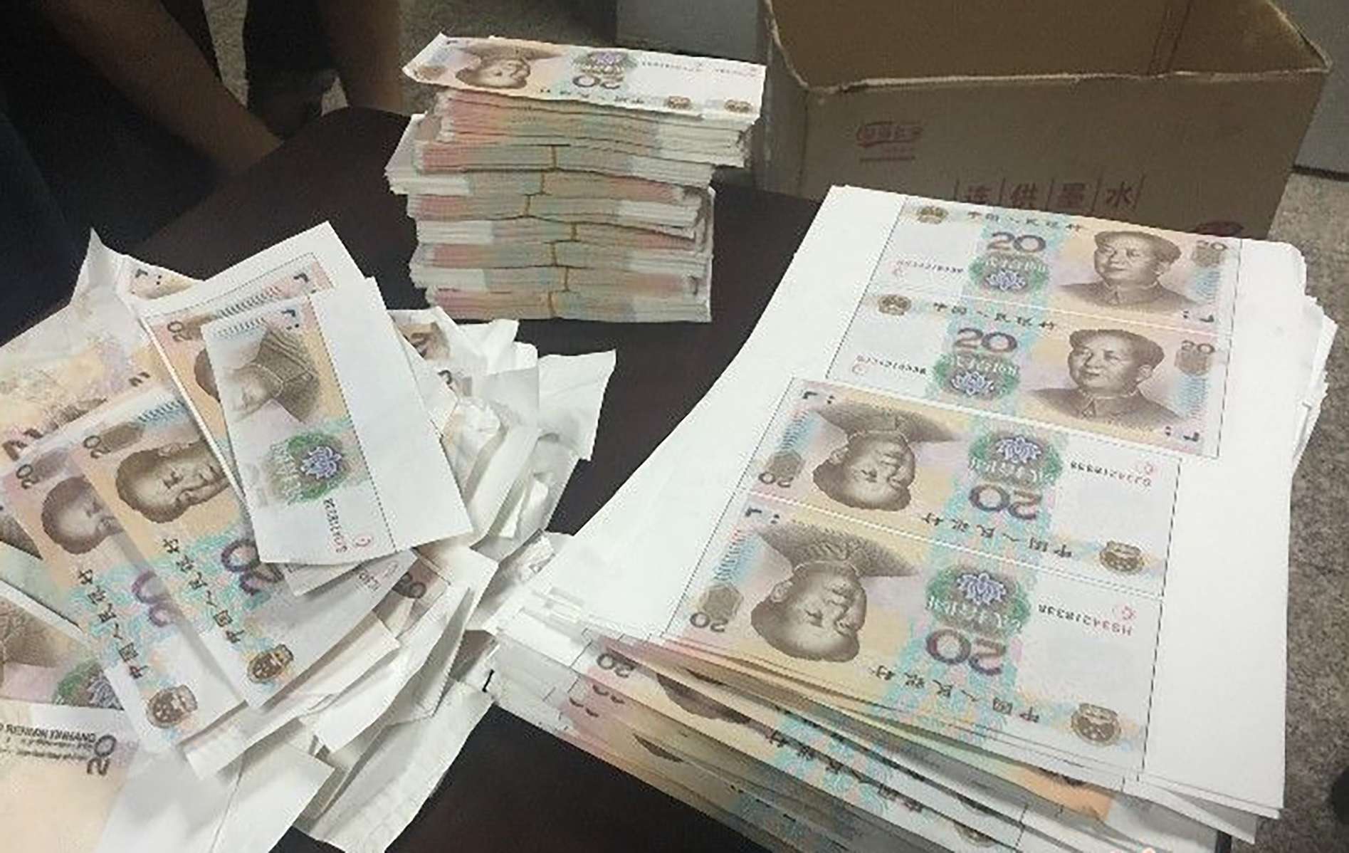 Police found bundles of fake notes at the home of two men. Photo: SCMP Pictures