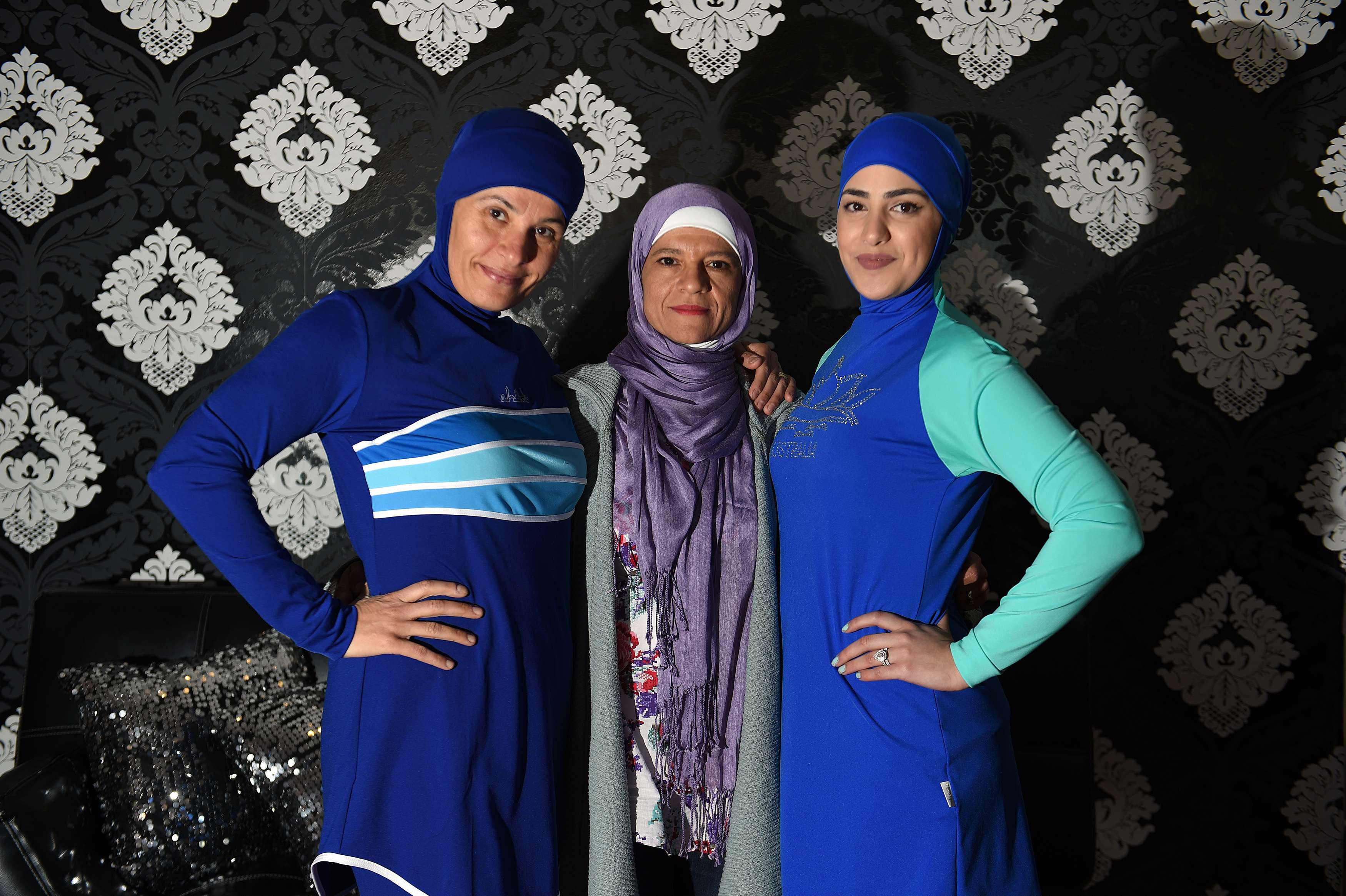 Models clad in burkini swimsuits pose with Australian-Lebanese designer Aheda Zanetti in western. Photo: AFP