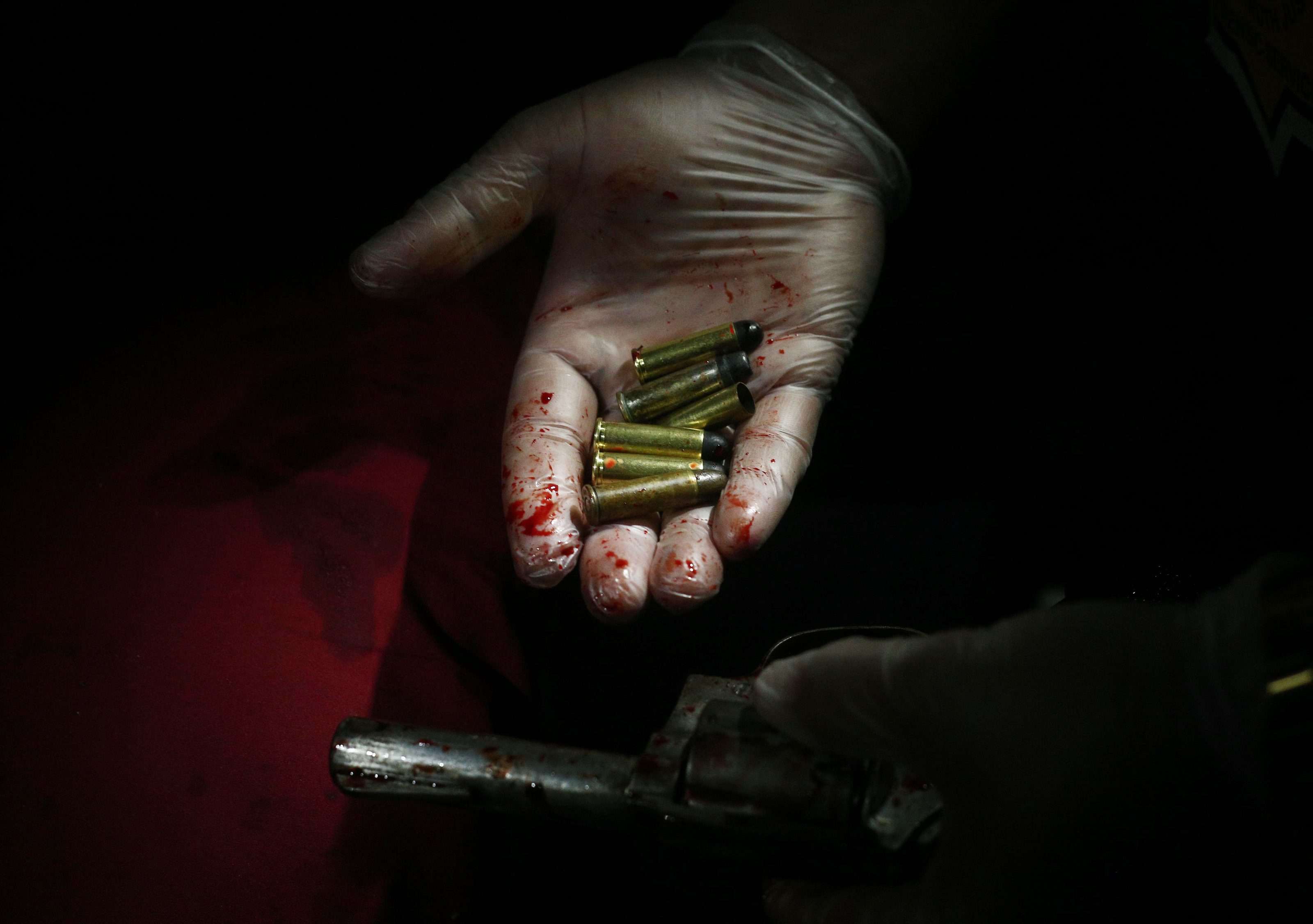 A police officer with recovered evidence after an operation against illegal drugs in Manila. Photo: EPA