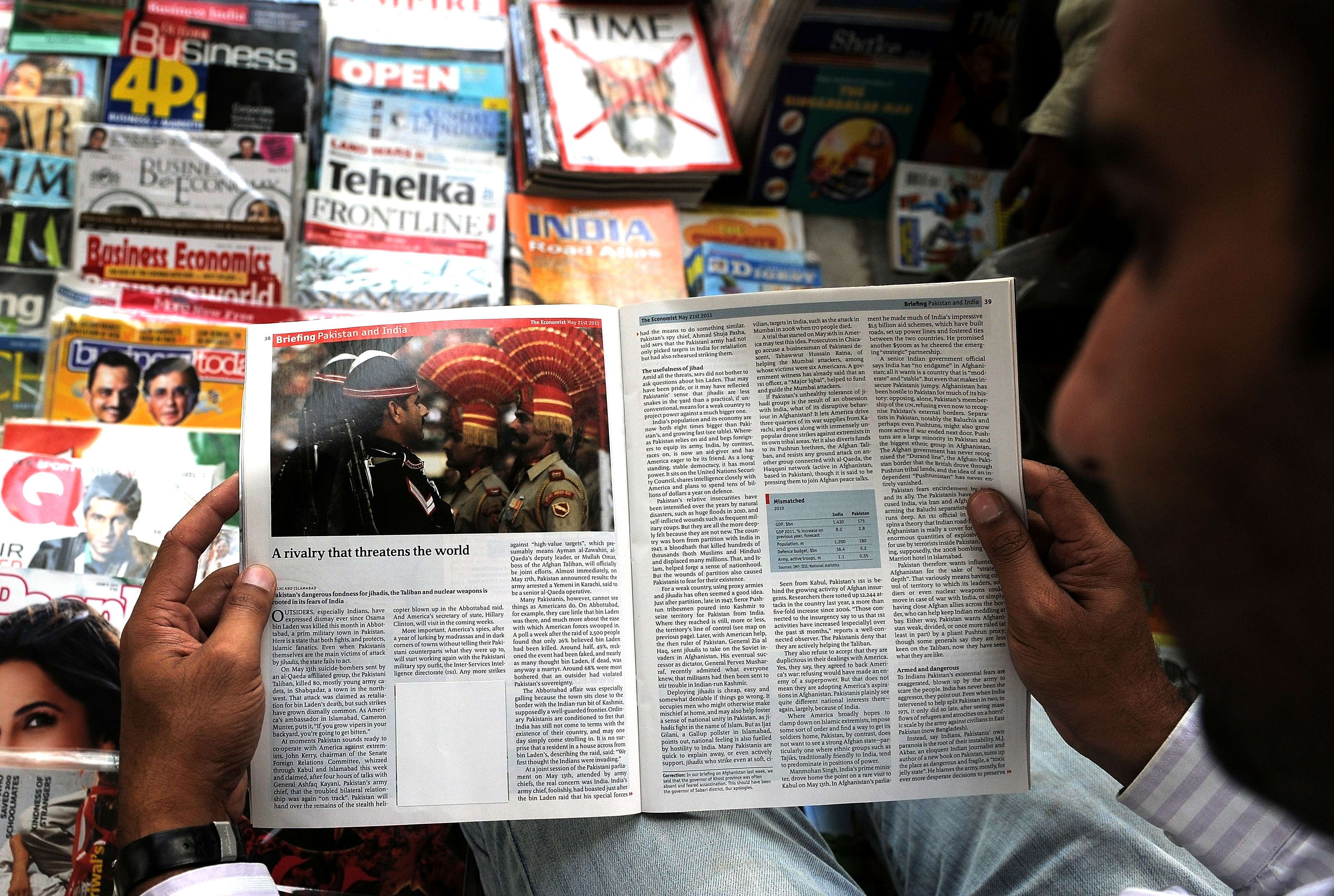 An Indian reads a censored magazine at a road-side stall in New Delhi. Photo: AFP