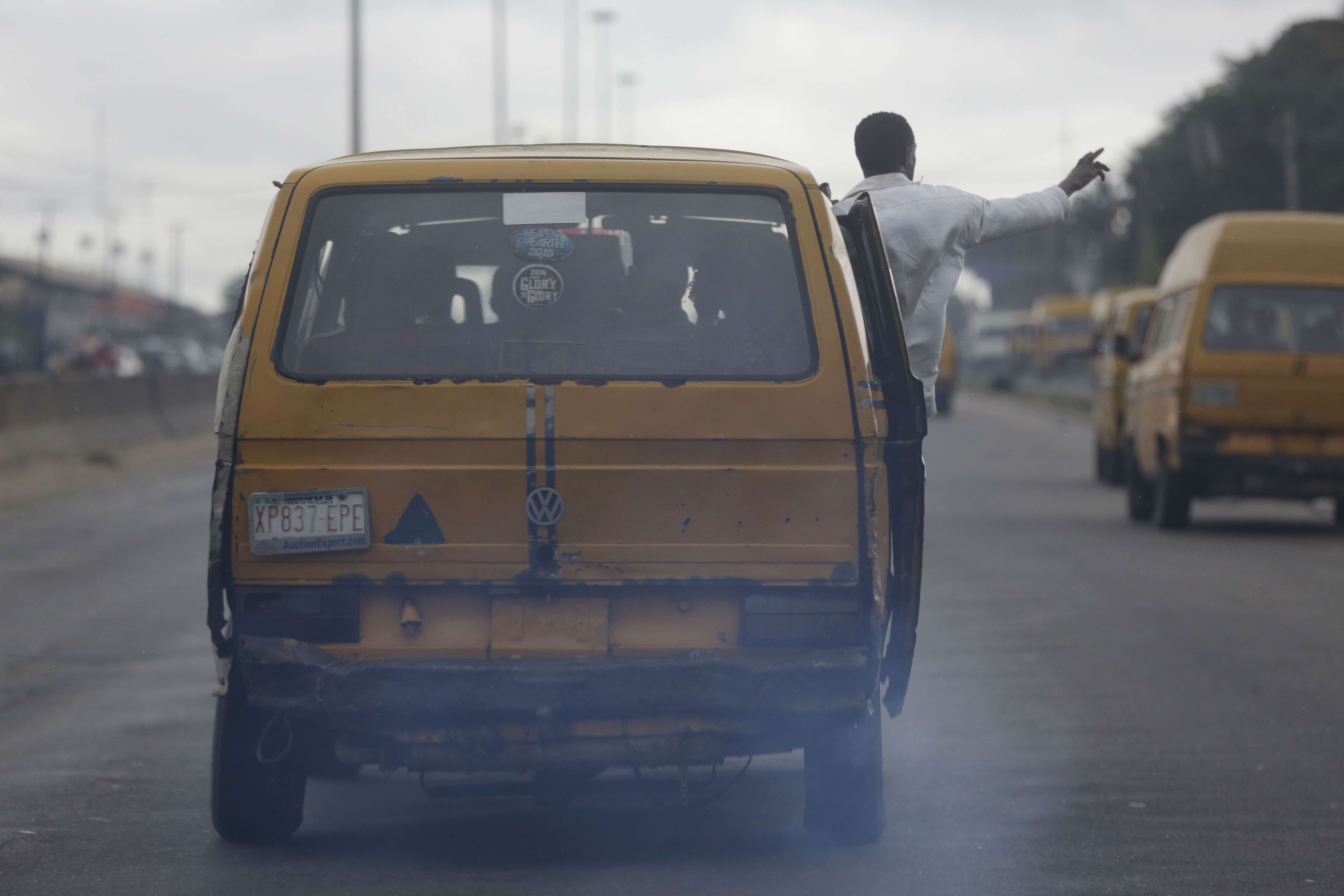 Fumes pour out of commercial buses operating on a Lagos street. The city successfully curbed the spread of Ebola through a vigorous public health effort and social mobilisation. Photo: AP