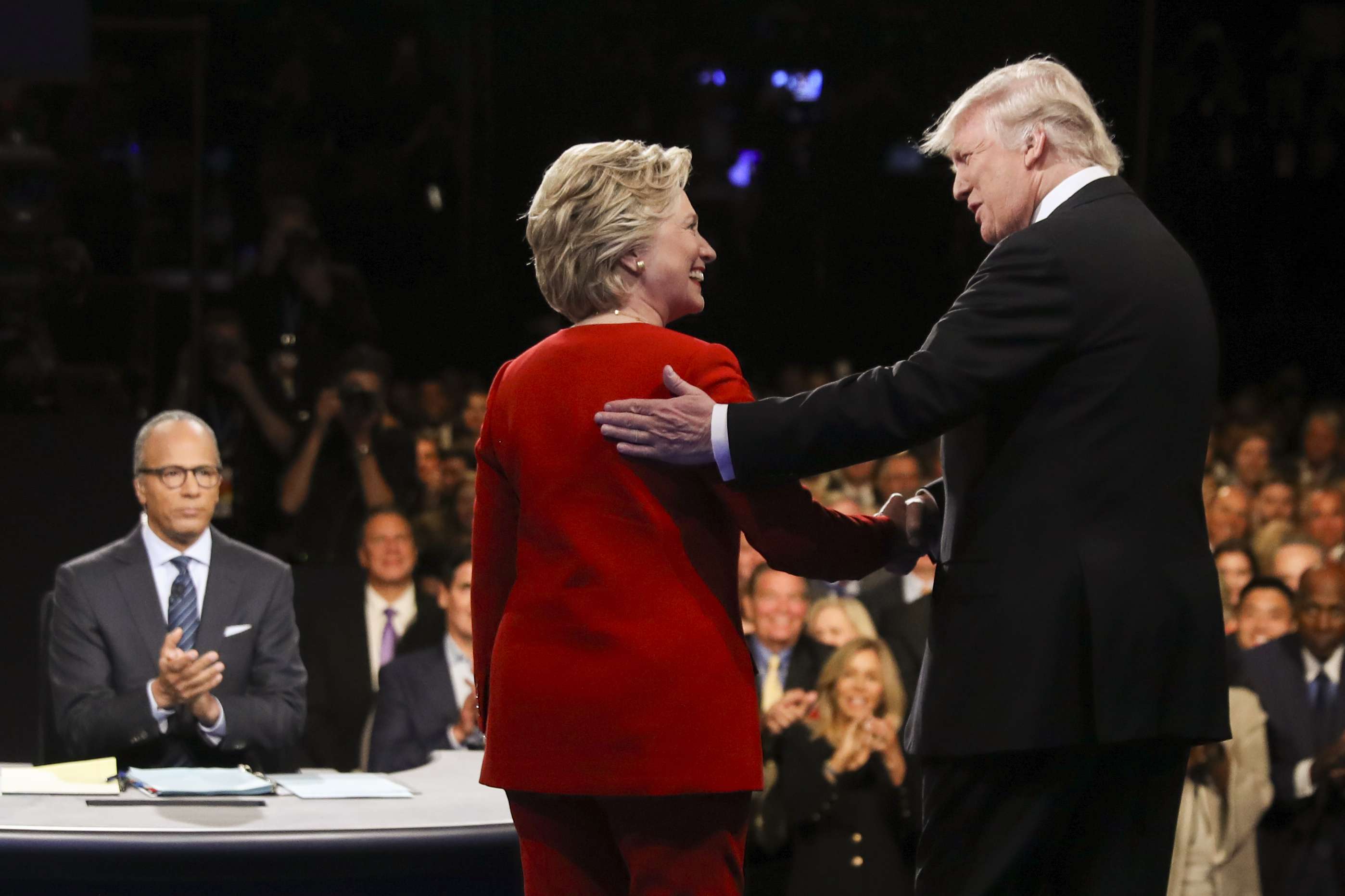 Democratic presidential nominee Hillary Clinton and Republican presidential nominee Donald Trump shake hands during the presidential debate. Photo: AP
