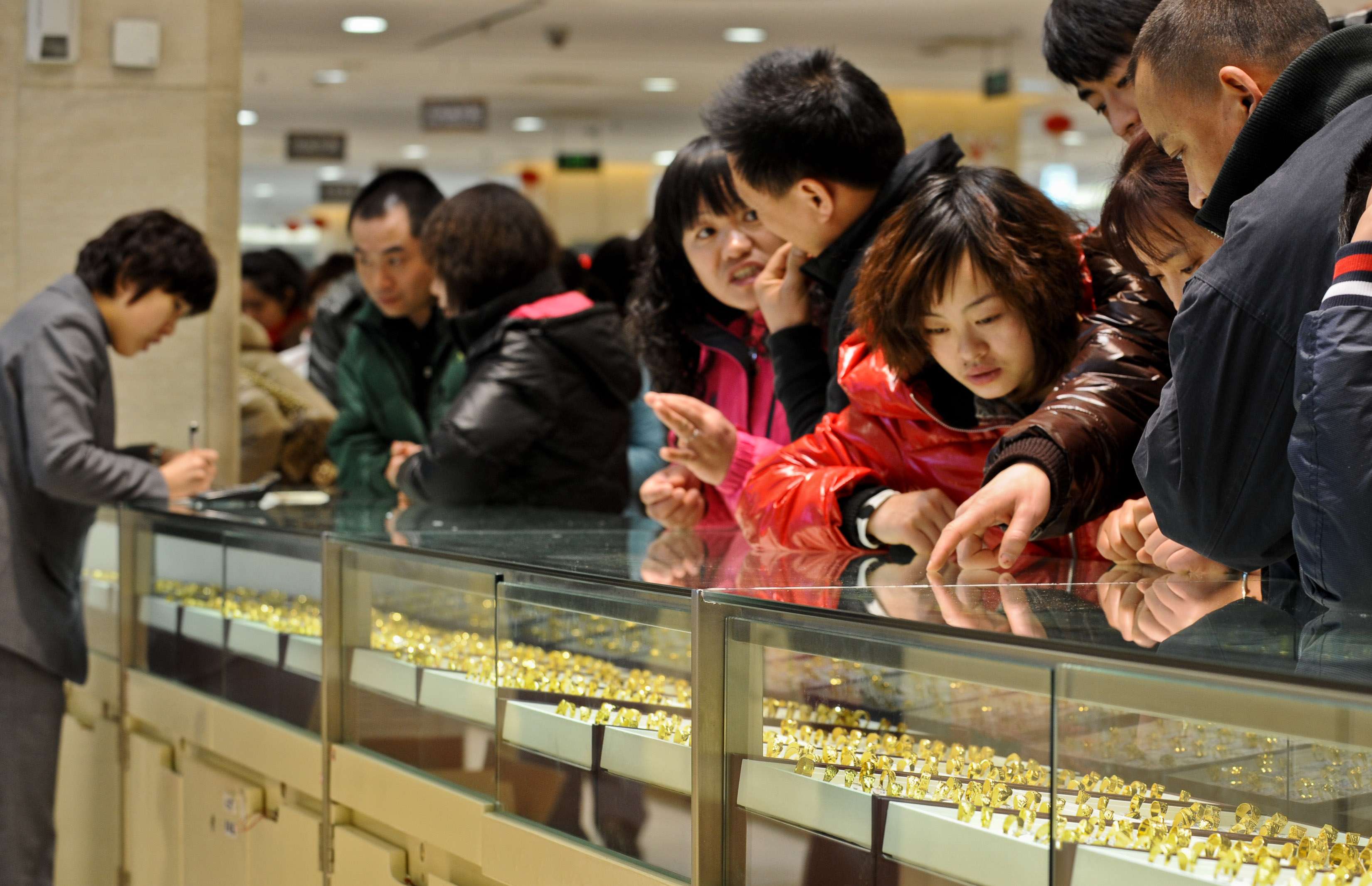 Gold draws the crowds at a shopping mall in Beijing in February 2011. China’s economy has enjoyed the effects of three generations’ savings being released at once. Photo: Xinhua