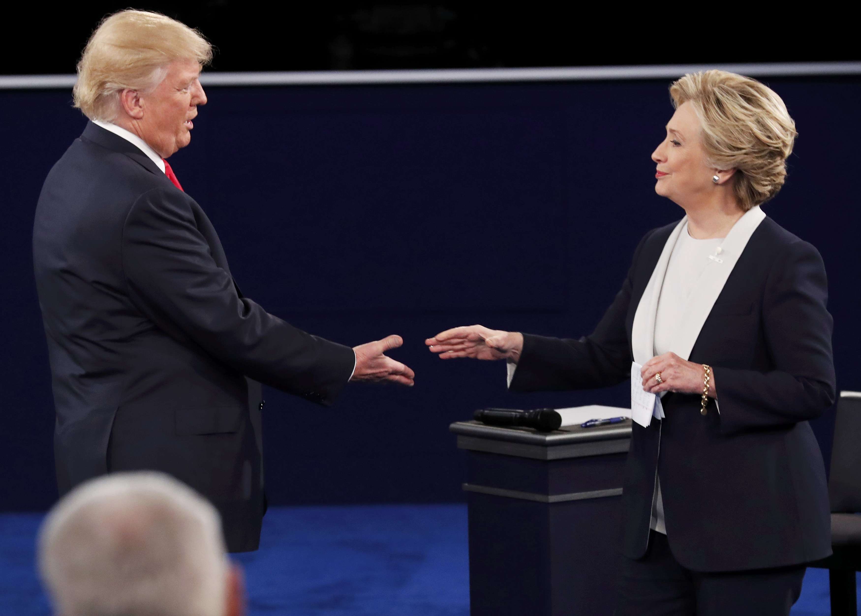 Republican nominee Donald Trump and Democratic nominee Hillary Clinton close the second US presidential debate with a handshake. Photo: Reuters