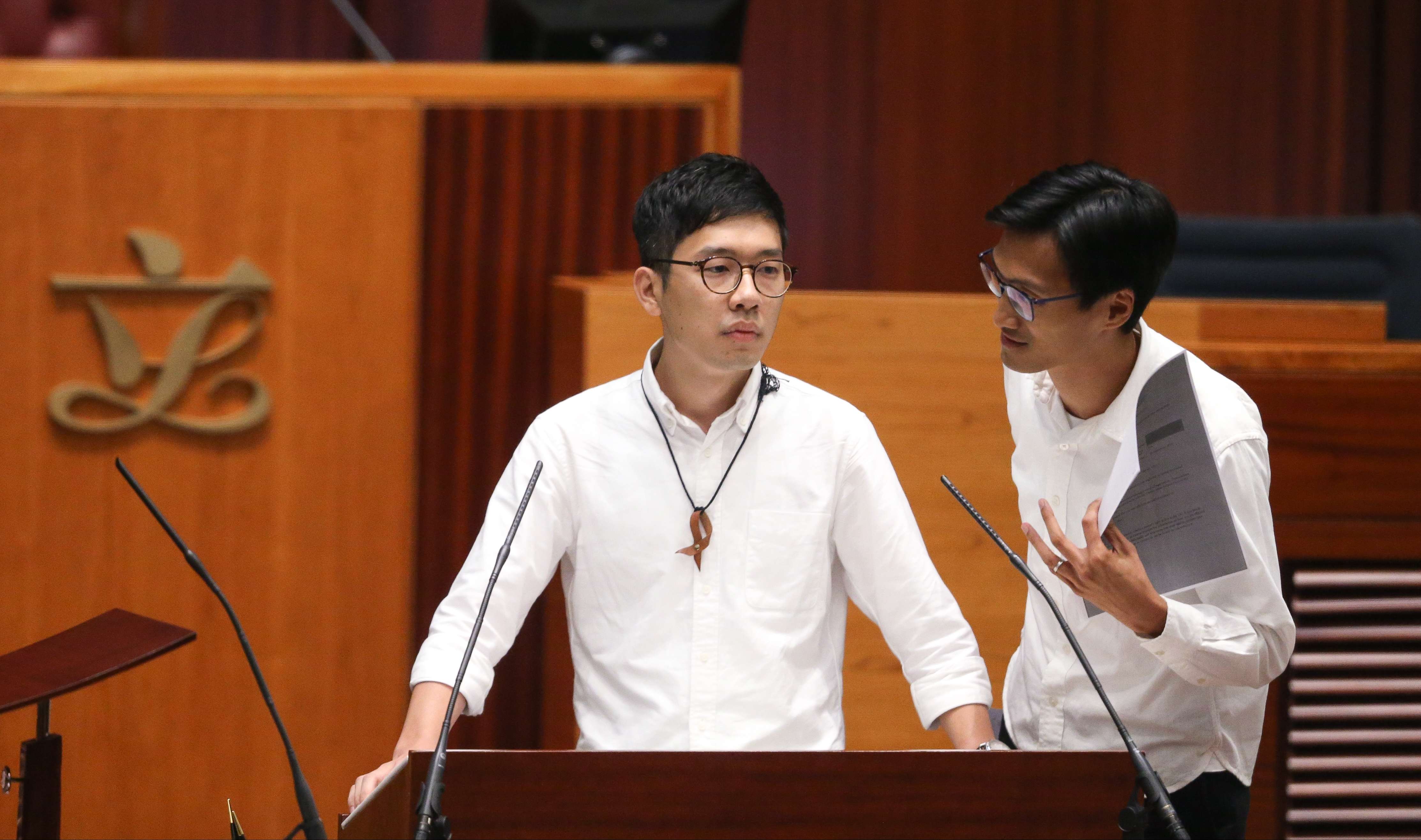 First-time lawmakers Nathan Law (left) and Eddie Chu during the oath-taking session for the sixth Legislative Council. Photo: Sam Tsang