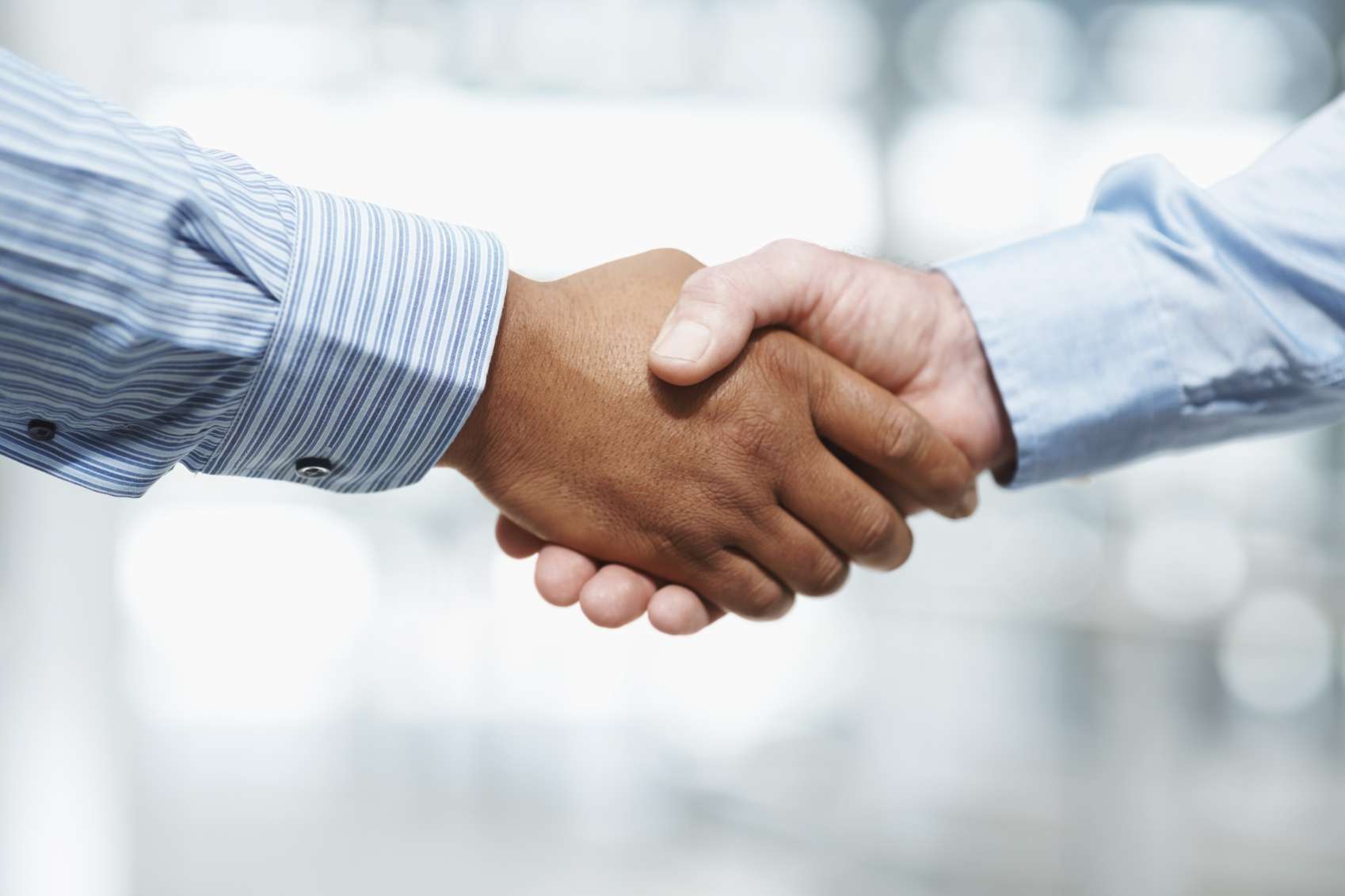*One time use only* Business deal - Closeup of a handshake against blur background