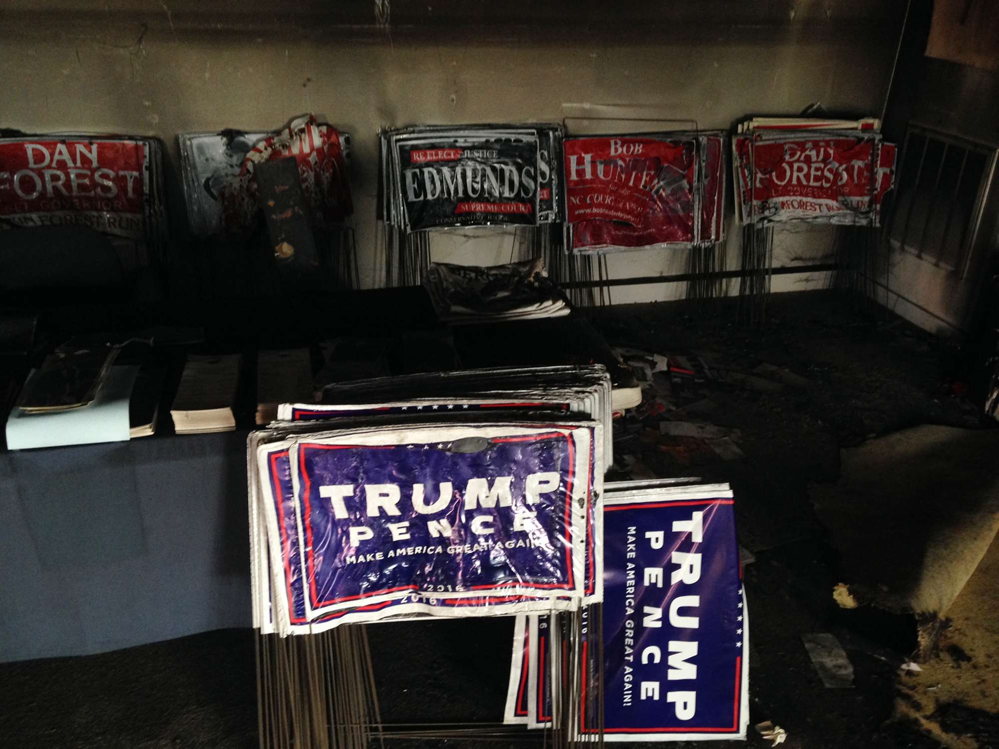Melted campaign signs are seen at the Orange County Republican Headquarters in Hillsborough, North Carolina, on Sunday, after a firebomb attack. Photo: AP