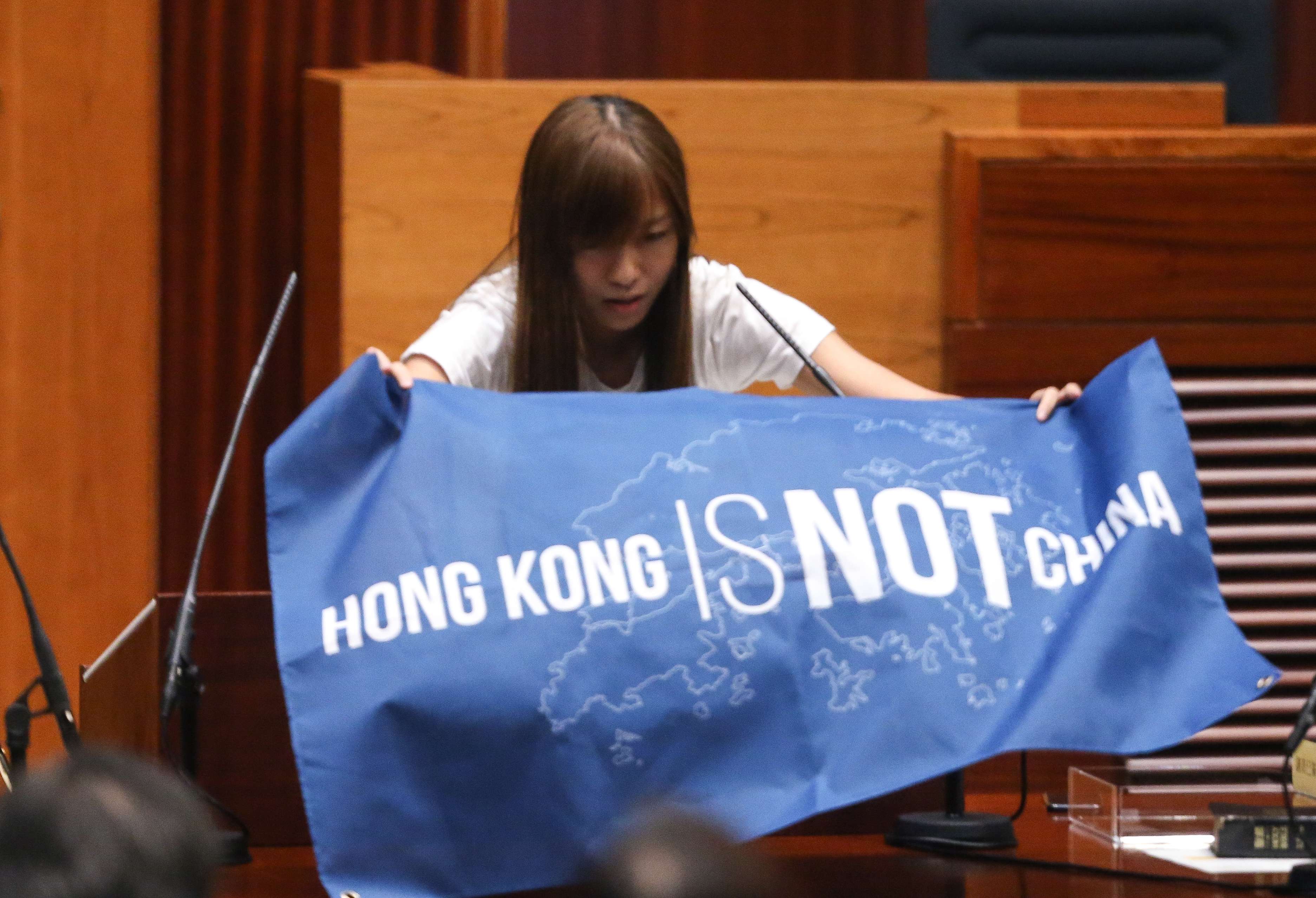 Yau Wai-ching displays a banner during her oath-taking last week. It is aggrieving that young localists could stoop so low as to refer to China as “Cheena”, a variation of the derogatory term “Shina” once used by the Japanese. Photo: Sam Tsang