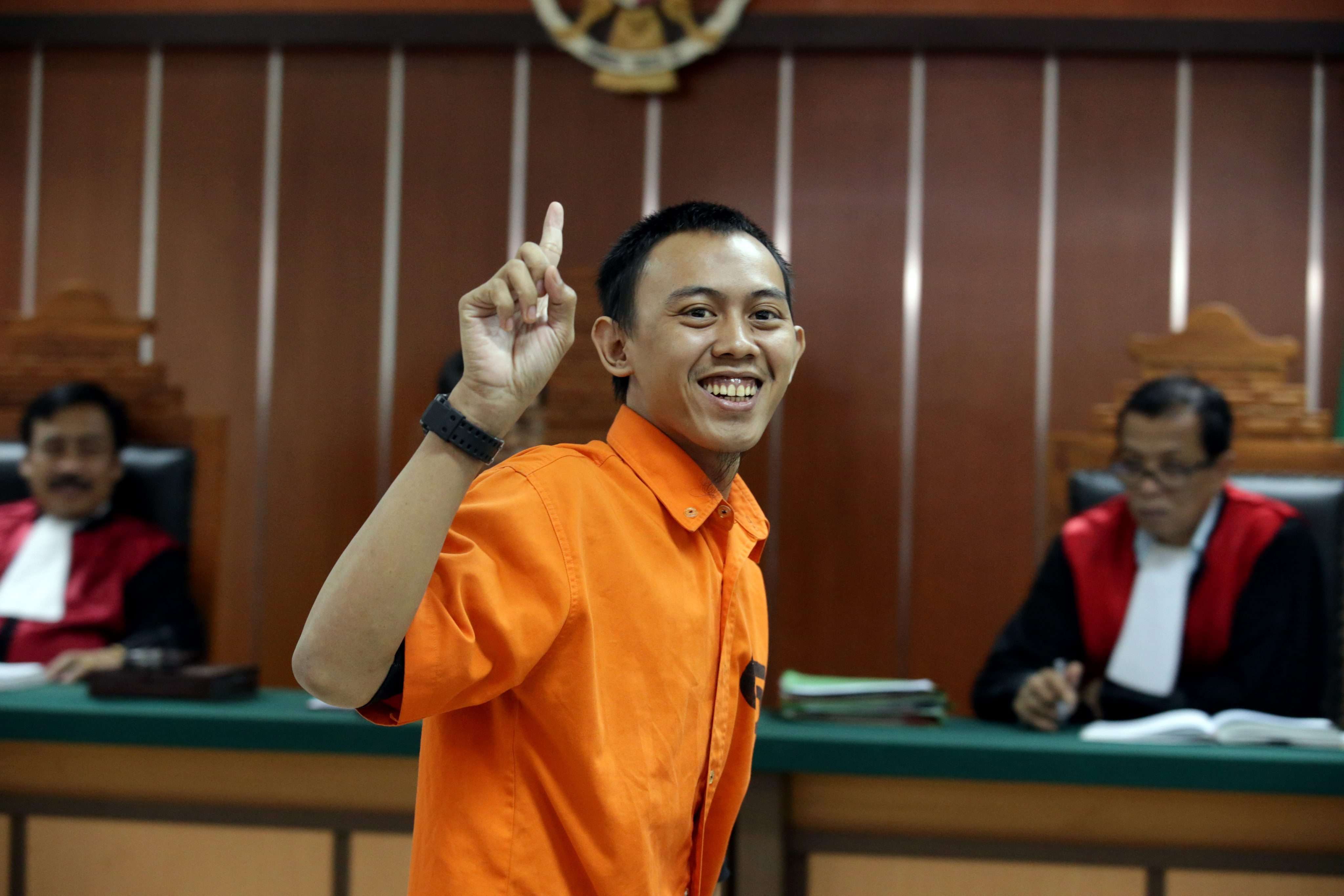 Indonesian militant Dodi Suridi, 23, smiles during his trial in Jakarta. Photo: EPA