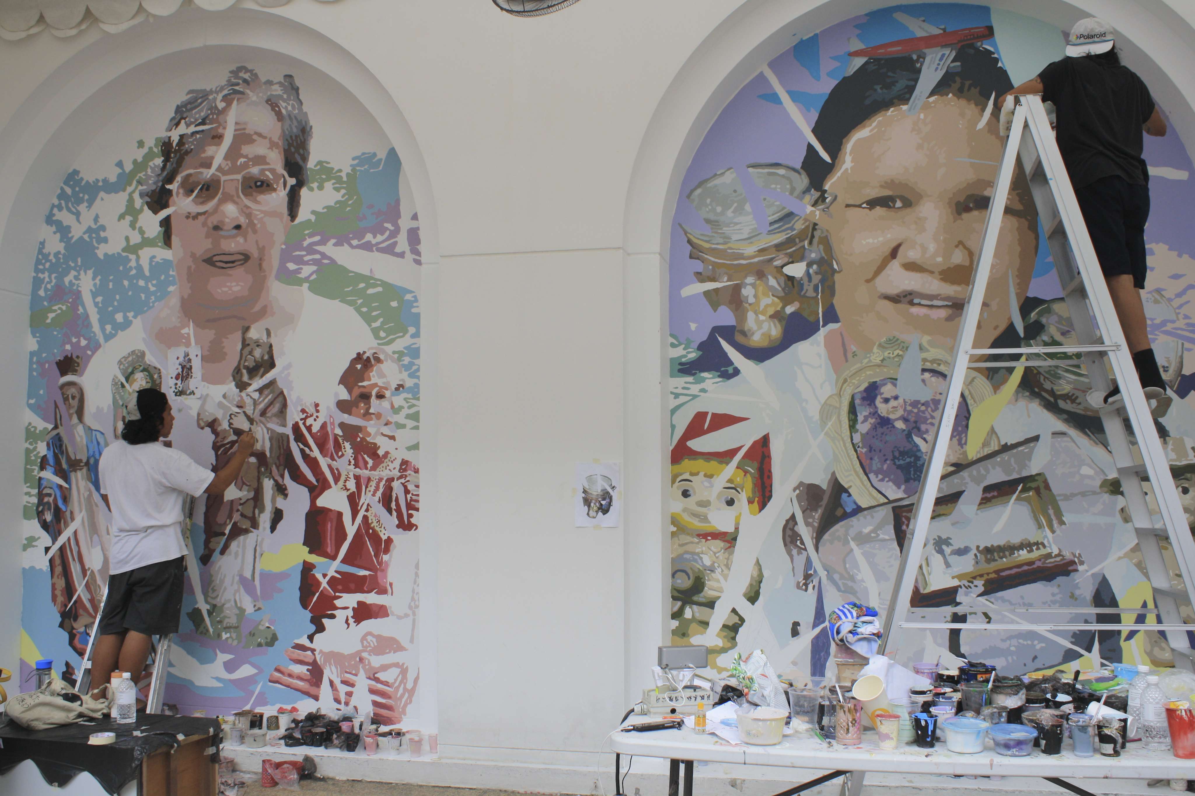 This image shows Dex Fernandez (right), painting murals in the courtyard of the Singapore Art Museum. Photos: Clara Chow