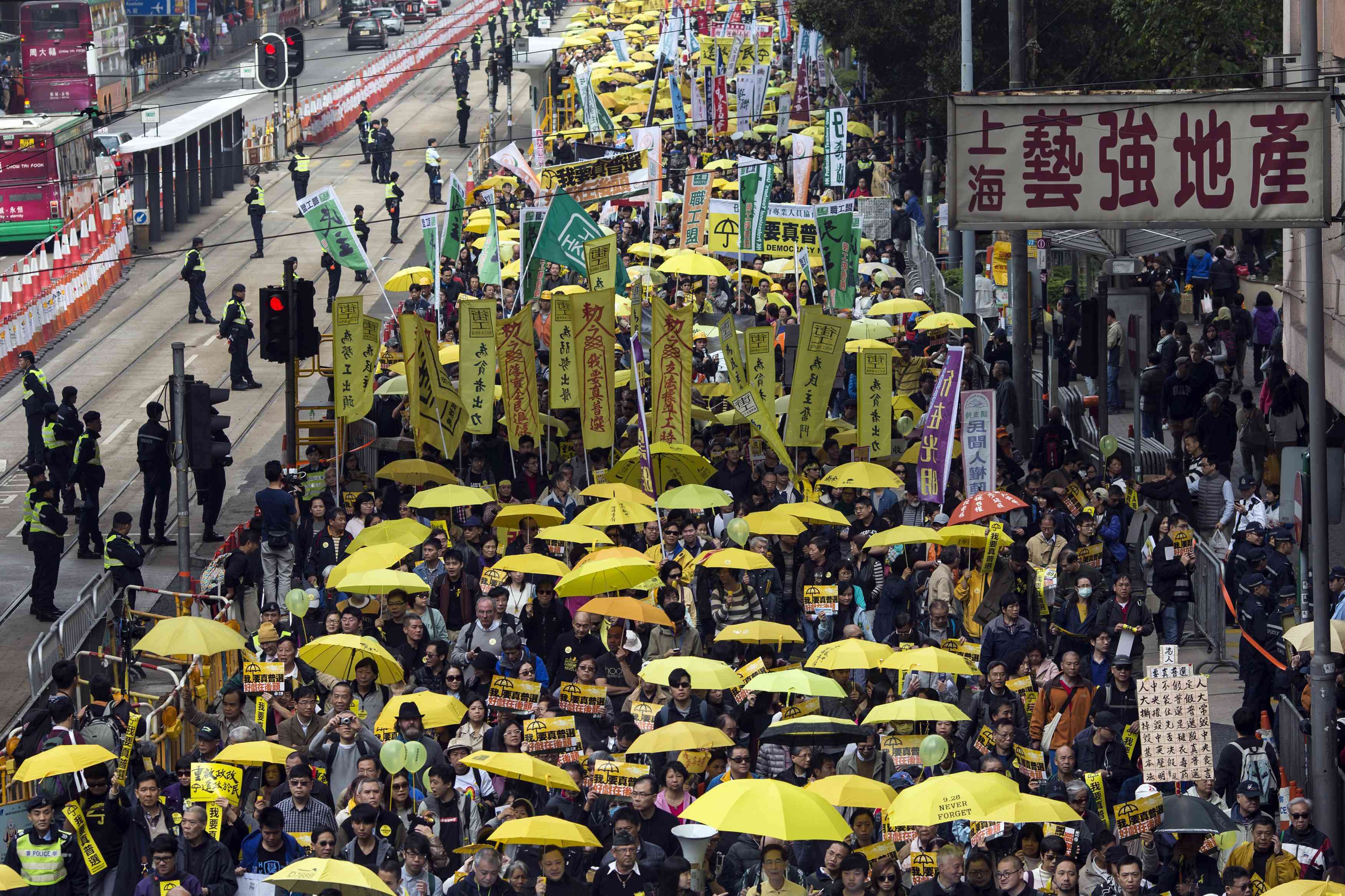 Thousands of pro-democracy protesters hold up yellow umbrellas, symbols of the Occupy movement, as they march to demand universal suffrage for Hong Kong, on February 1 last year. Photo: Reuters