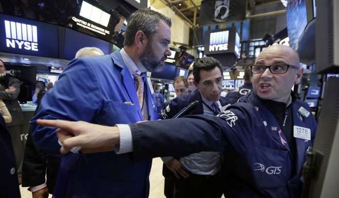Specialist Mario Picone, right, works at his post on the floor of the New York Stock Exchange, Wednesday, Nov. 9, 2016. Stocks are moving solidly higher in midday trading on Wall Street following Donald Trump's upset victory over Hillary Clinton in the U.S. presidential election. (AP Photo/Richard Drew)