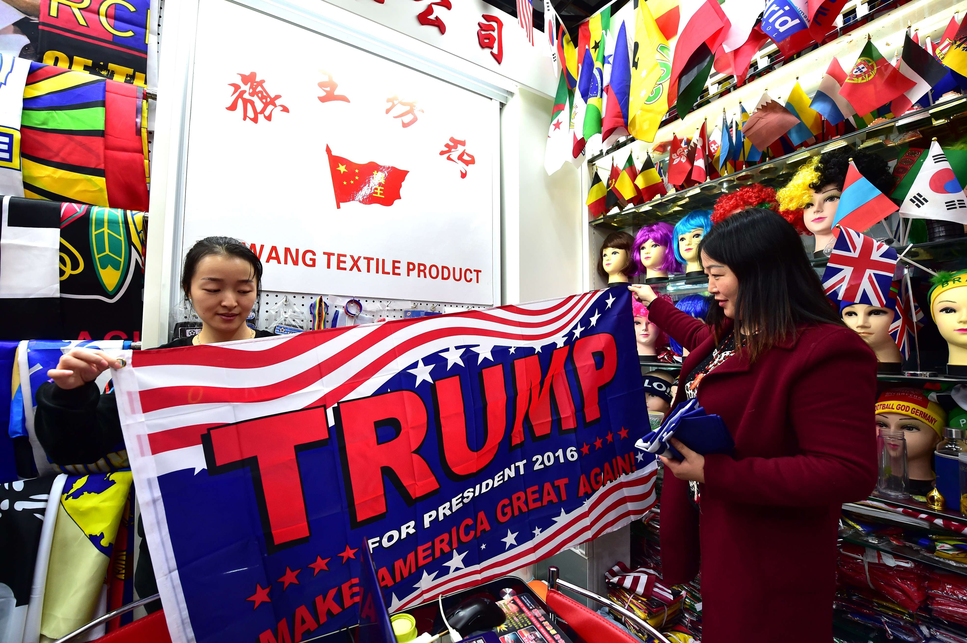 A shop assistant with a pro-Trump banner at the China Yiwu International Trade City. Photo: AFP