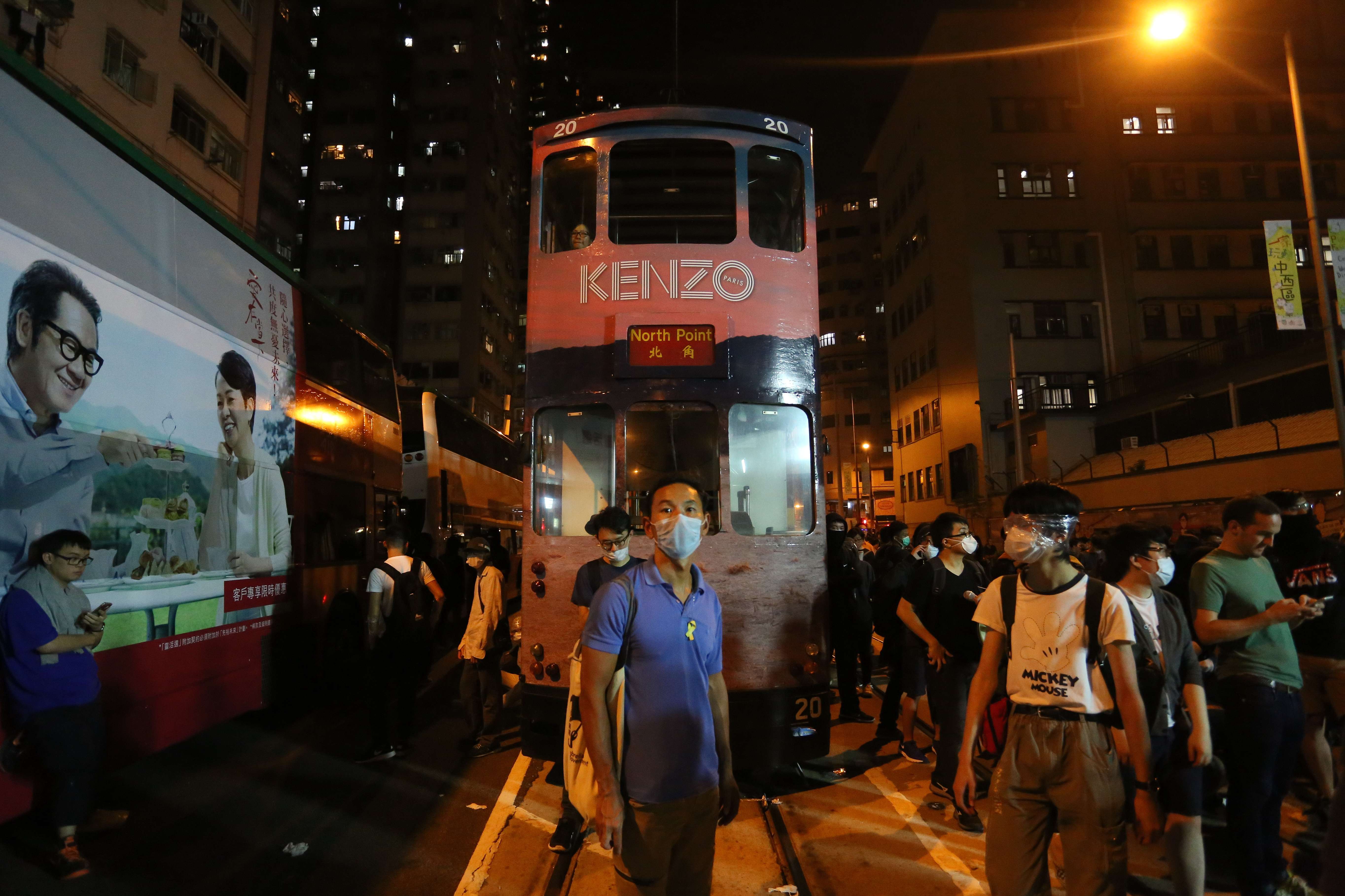 Protesters outside Western Police Station on Sunday evening in Hong Kong. There were repeated clashes between officers and protesters who had had broken off from an earlier, peaceful rally against Beijing's Basic Law interpretation over the Legco oath-taking row. Photo: AFP