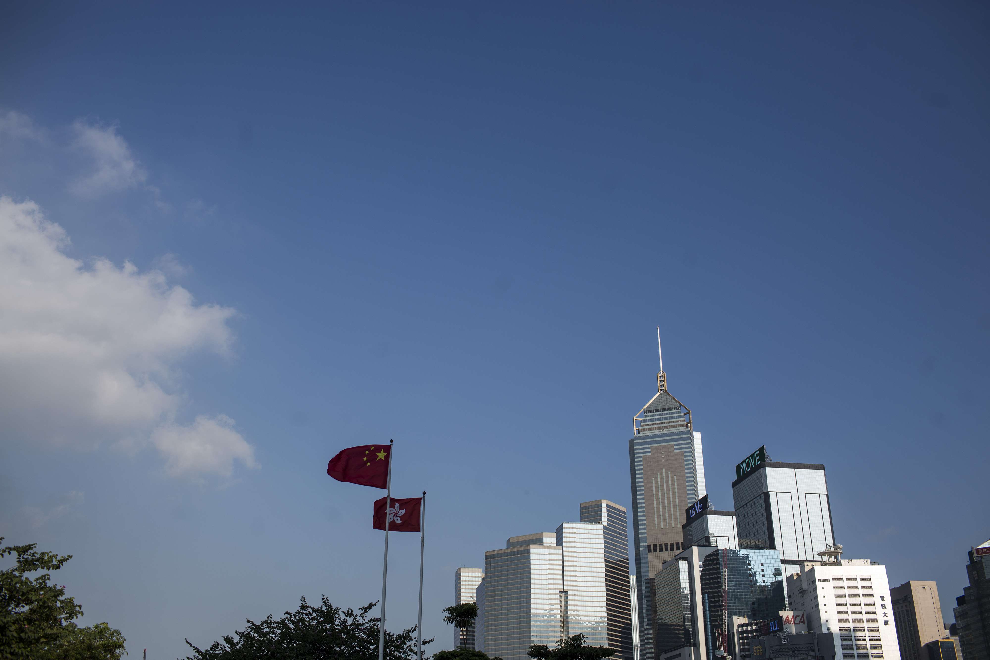 The Chinese national flag and the Hong Kong flag fly in front of buildings in Central. Hong Kong’s success as an international financial centre is not inevitable, and is closely tied to China’s history. Photo: Bloomberg