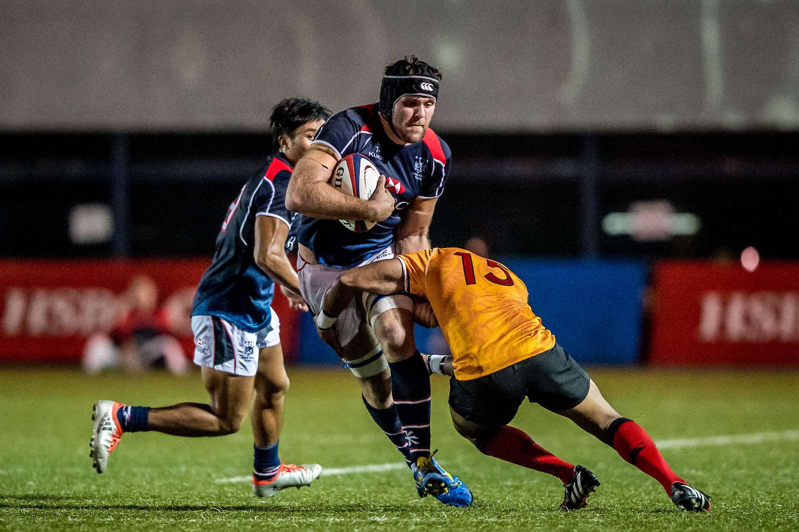 Dan Falvey takes on a tackler in Hong Kong’s win over Papua New Guinea in the Cup of Nations. Photo: SCMP Pictures