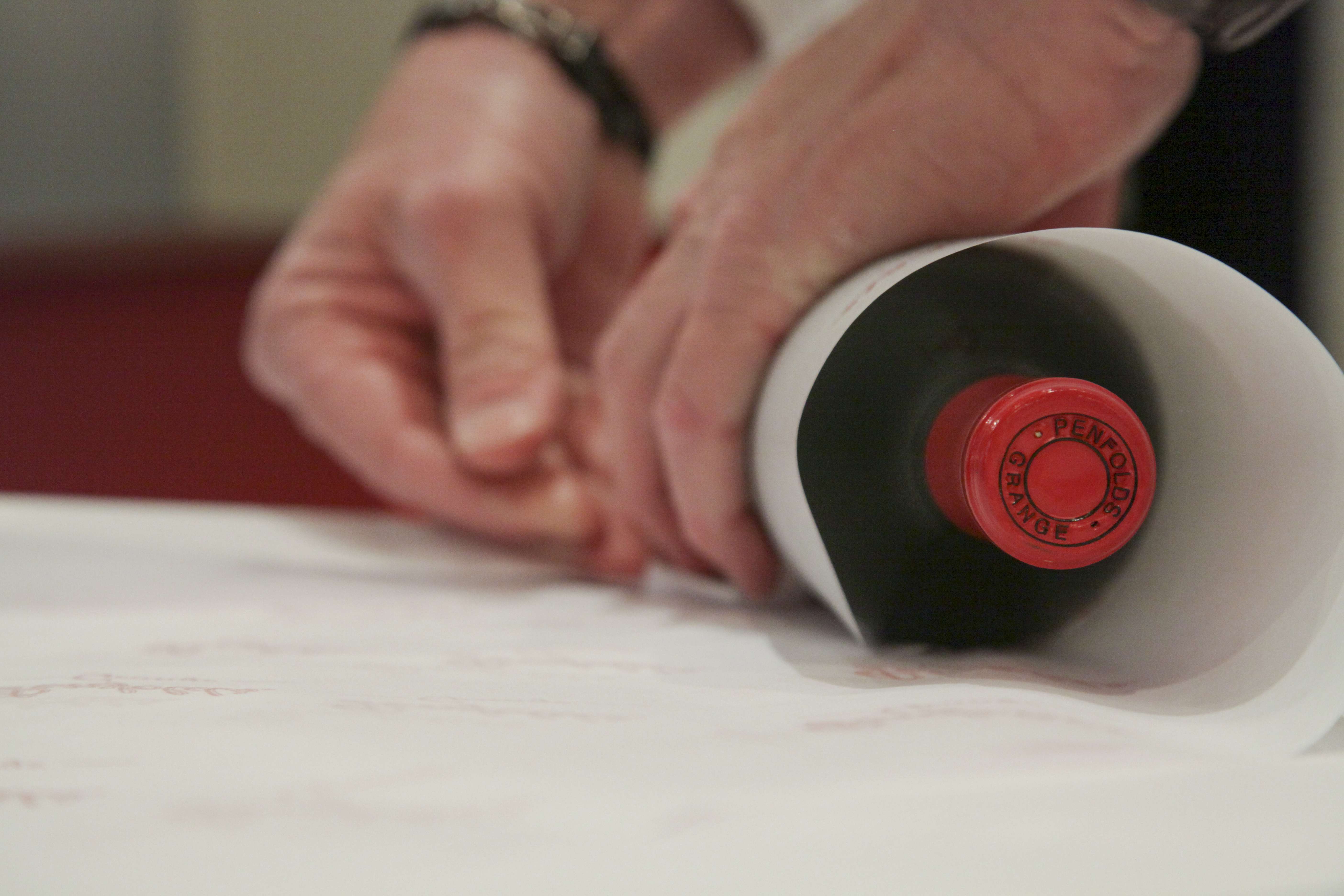 A recorked bottle of Penfolds wine being wrapped at a Penfolds recorking night in the US.