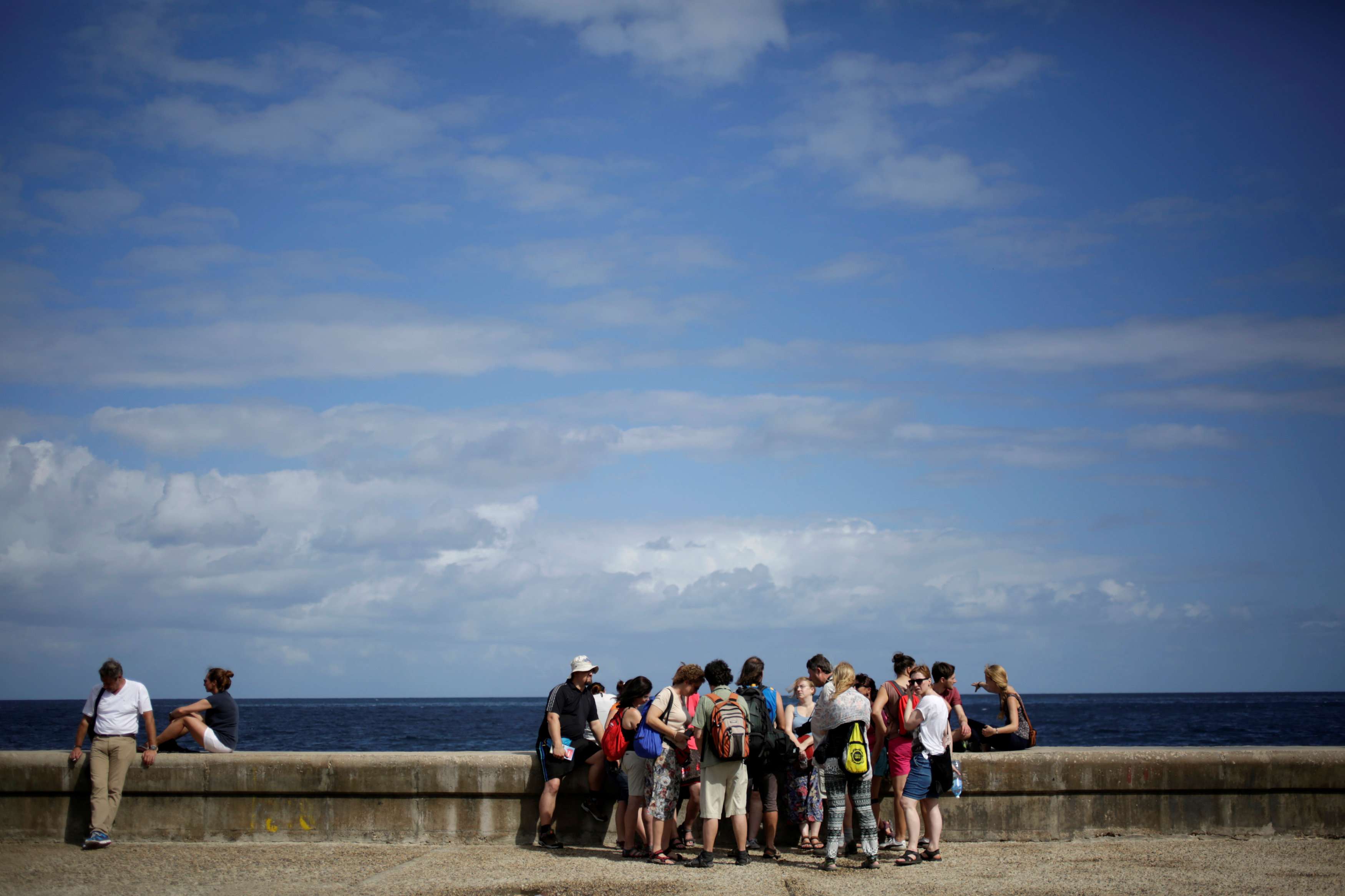 Tourists stand on Havana's seafront boulevard. Photo: Reuters