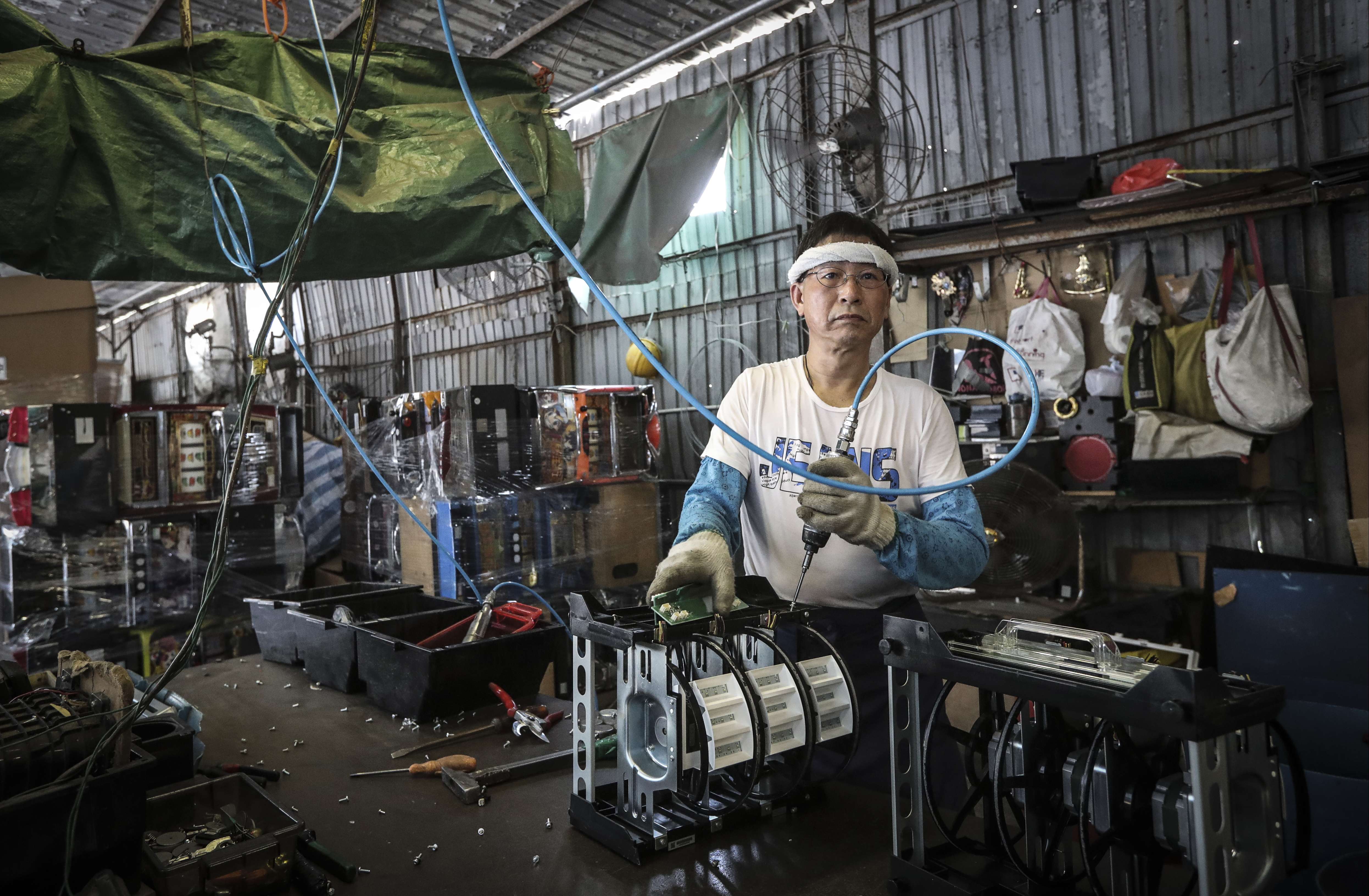 A worker at an e-waste dumping ground in Yuen Long in July. Photo: Bruce Yan