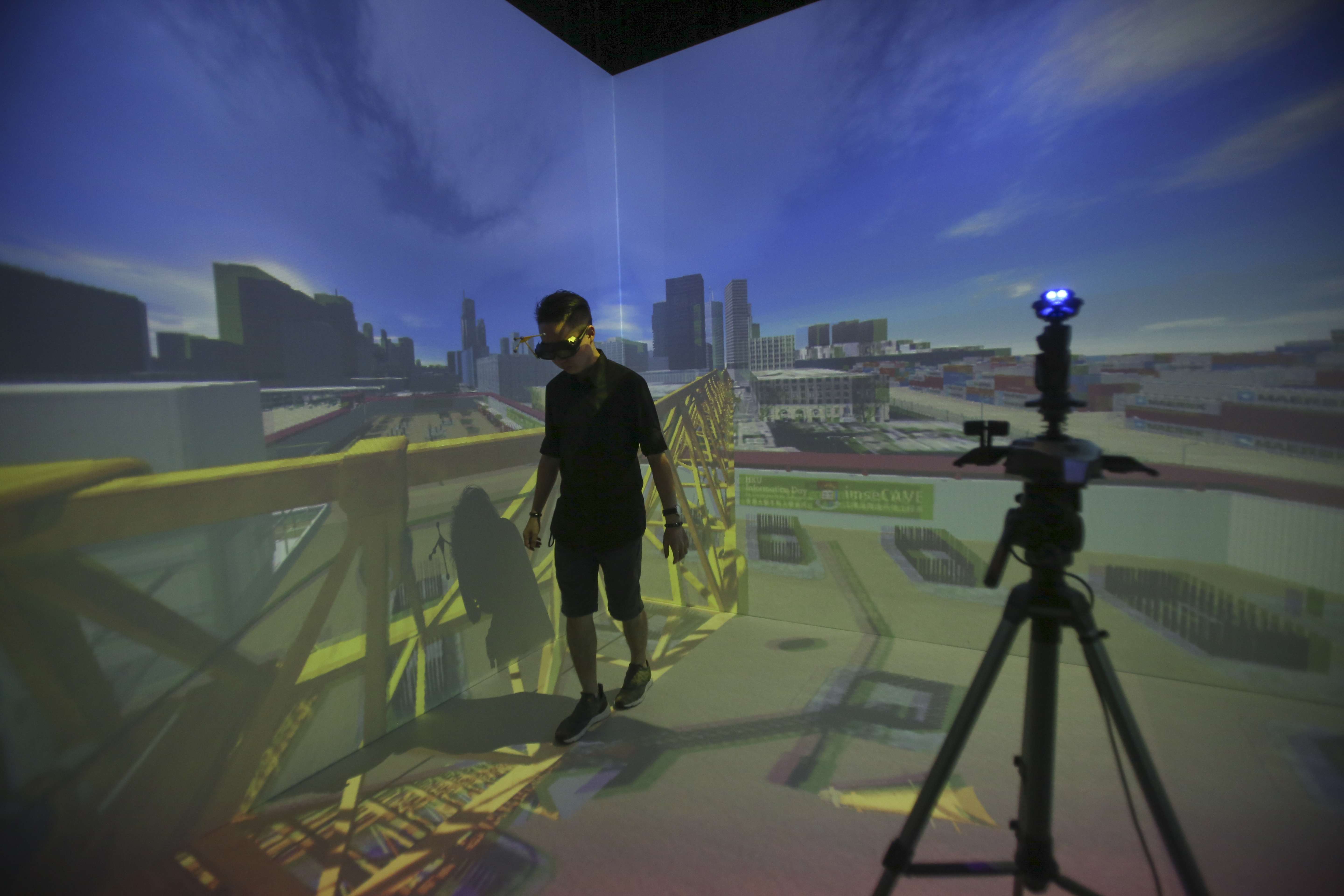 A member of a HKU research team demonstrates how to use virtual reality systems for training. The team has developed a VR training system for commercial use. Photo: Chen Xiaomei