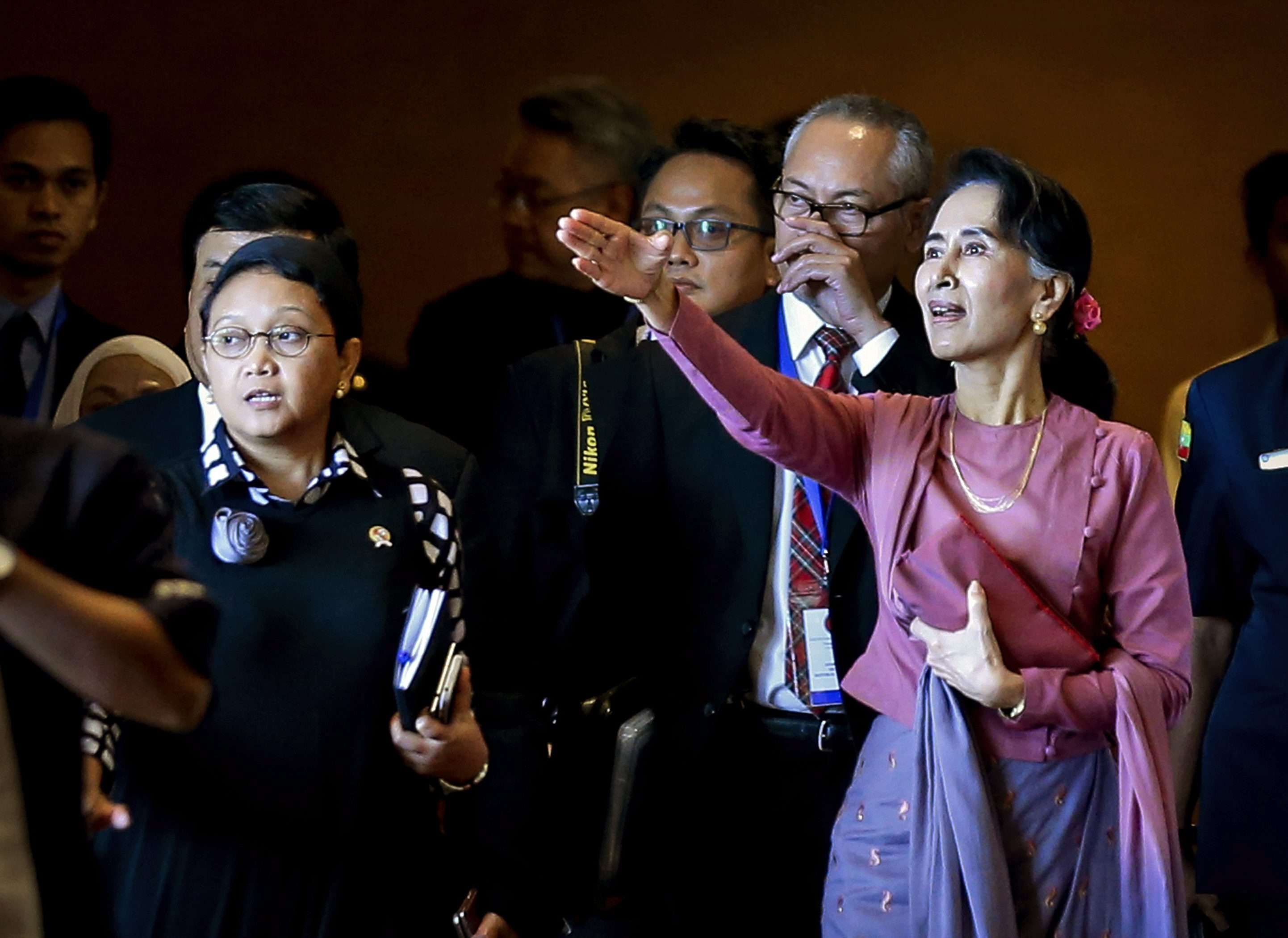 Aung San Suu Kyi, state counsellor and foreign minister of Myanmar, gestures as she and Indonesian Foreign Minister Retno Marsudi leave the Asean Foreign Ministers’ meeting in Yangon where the Rohingya issue was discussed, on December 19. Photo: EPA