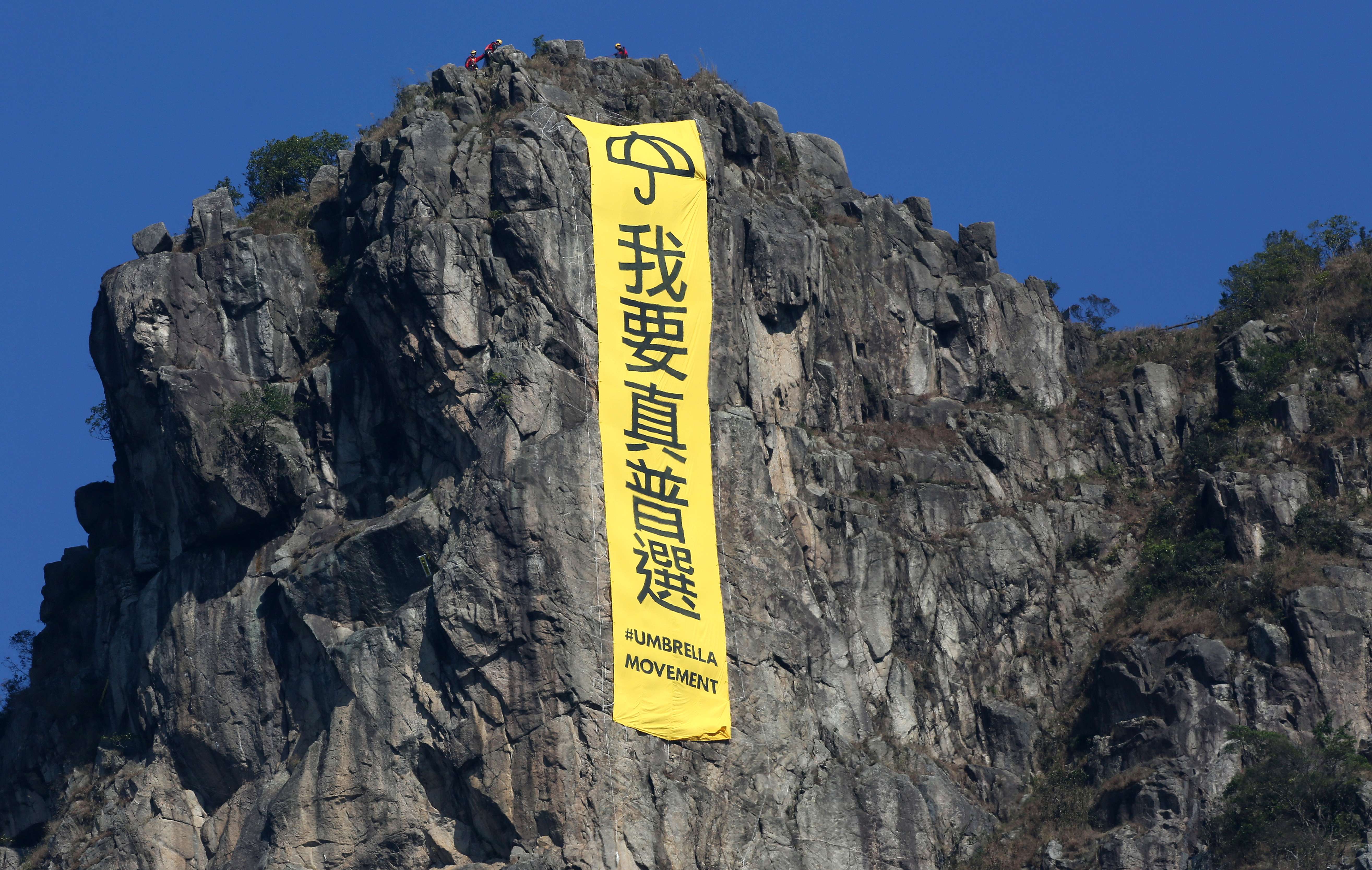A banner hangs from Lion Rock in 2014, calling for “true universal suffrage”. Photo: Nora Tam