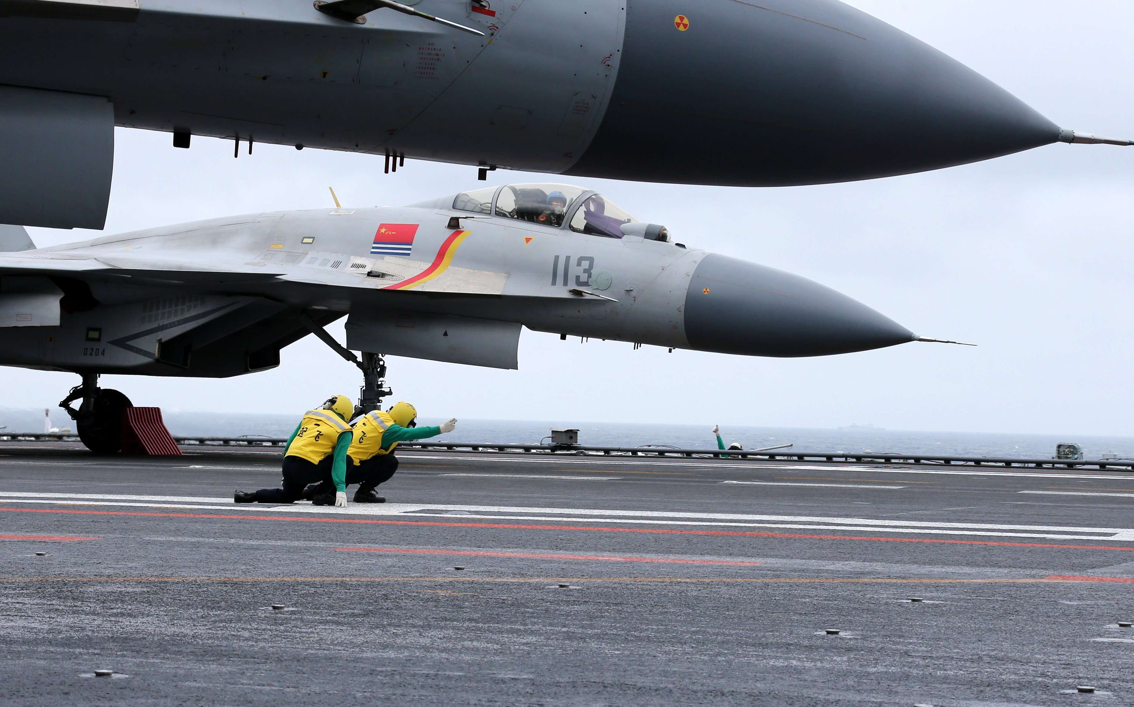 A J-15 jet fighter prepares to take off from the deck of the Liaoning, China's first aircraft carrier, during a drill in the South China Sea on Monday. Photo: CNS