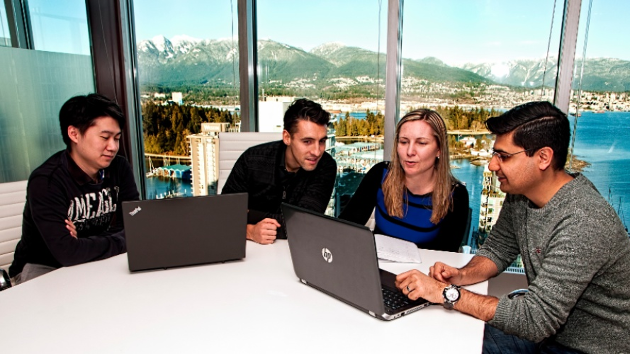 Left to right: Stanley Li, Michael Jover, Marla Dranfield and Osama Khan discuss a project at Progressa’s Vancouver offices. Photo: Chung Chow/BIV