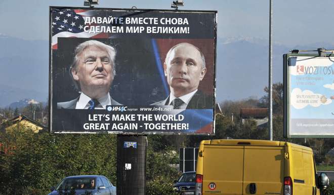 Cars pass by a billboard showing US President-elect Donald Trump and Russian President Vladimir Putin in the town of Danilovgrad. Photo: AFP