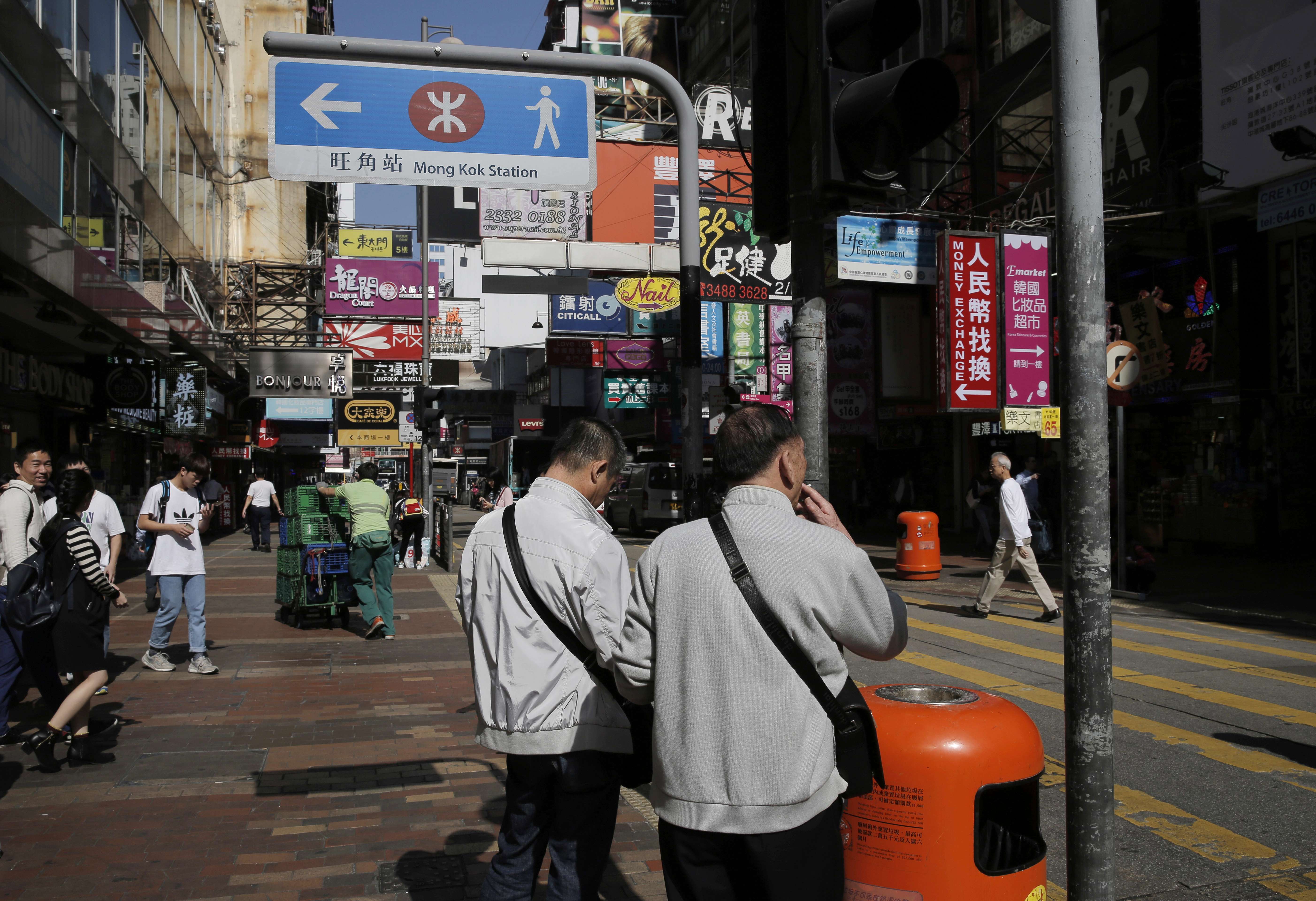 Pedestrians on a Mong Kok street. Housing, transport and economic development are important. But the government should be cautioned against falling back on an outdated mode of urban planning that focuses only on hardware – mostly for vehicles – while ignoring the software that makes life bearable for the average person on the pavement. Photo: AP