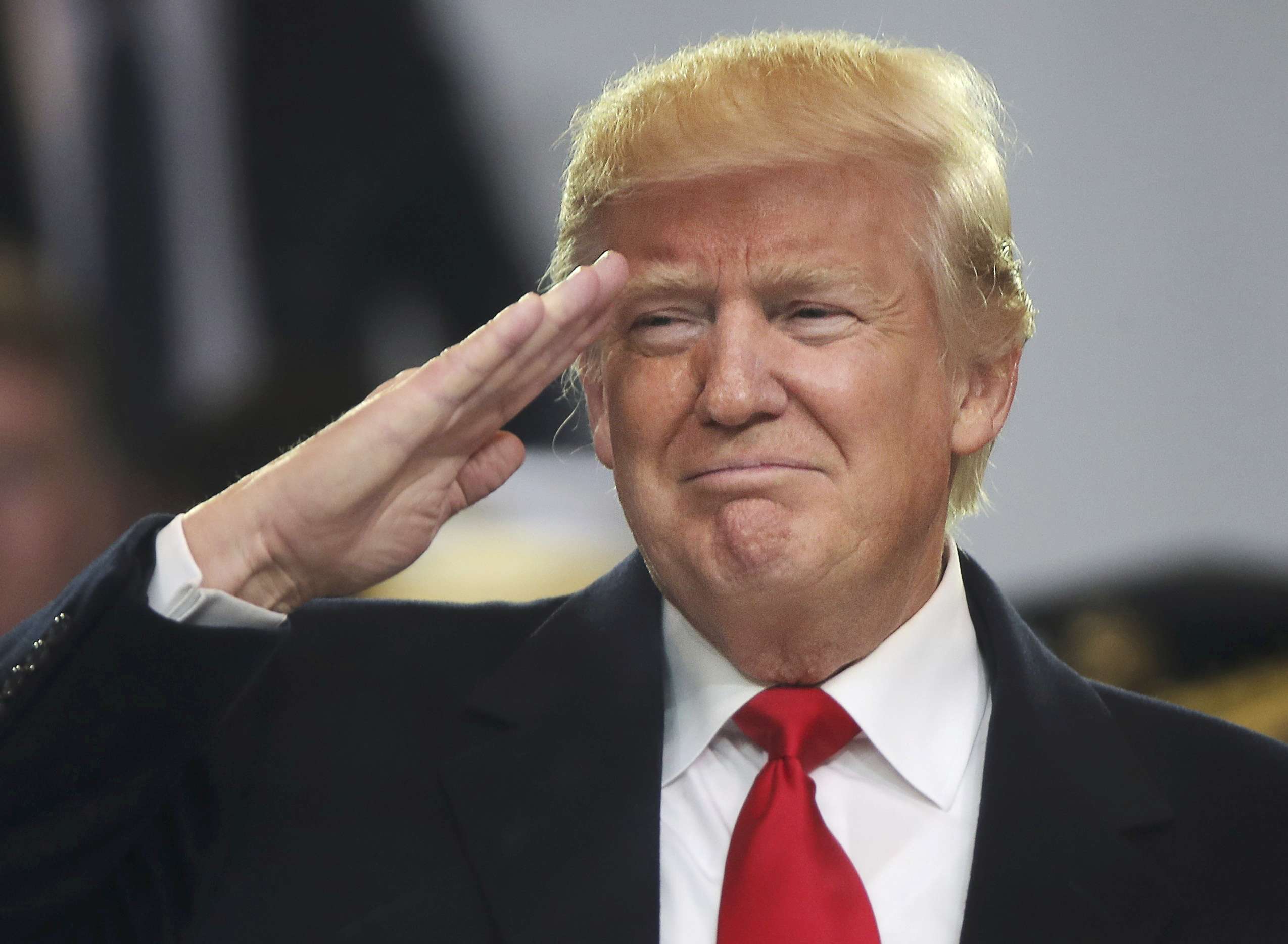US President Donald Trump salutes participants during the inaugural parade in Washington on Friday. Photo: Reuters