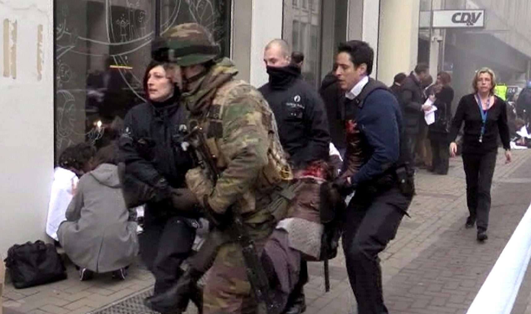 Belgian policemen and a soldier carrying an injured person after the March 22 terrorist attack on the Maelbeek Metro station in Brussels, Belgium. Photo: EPA