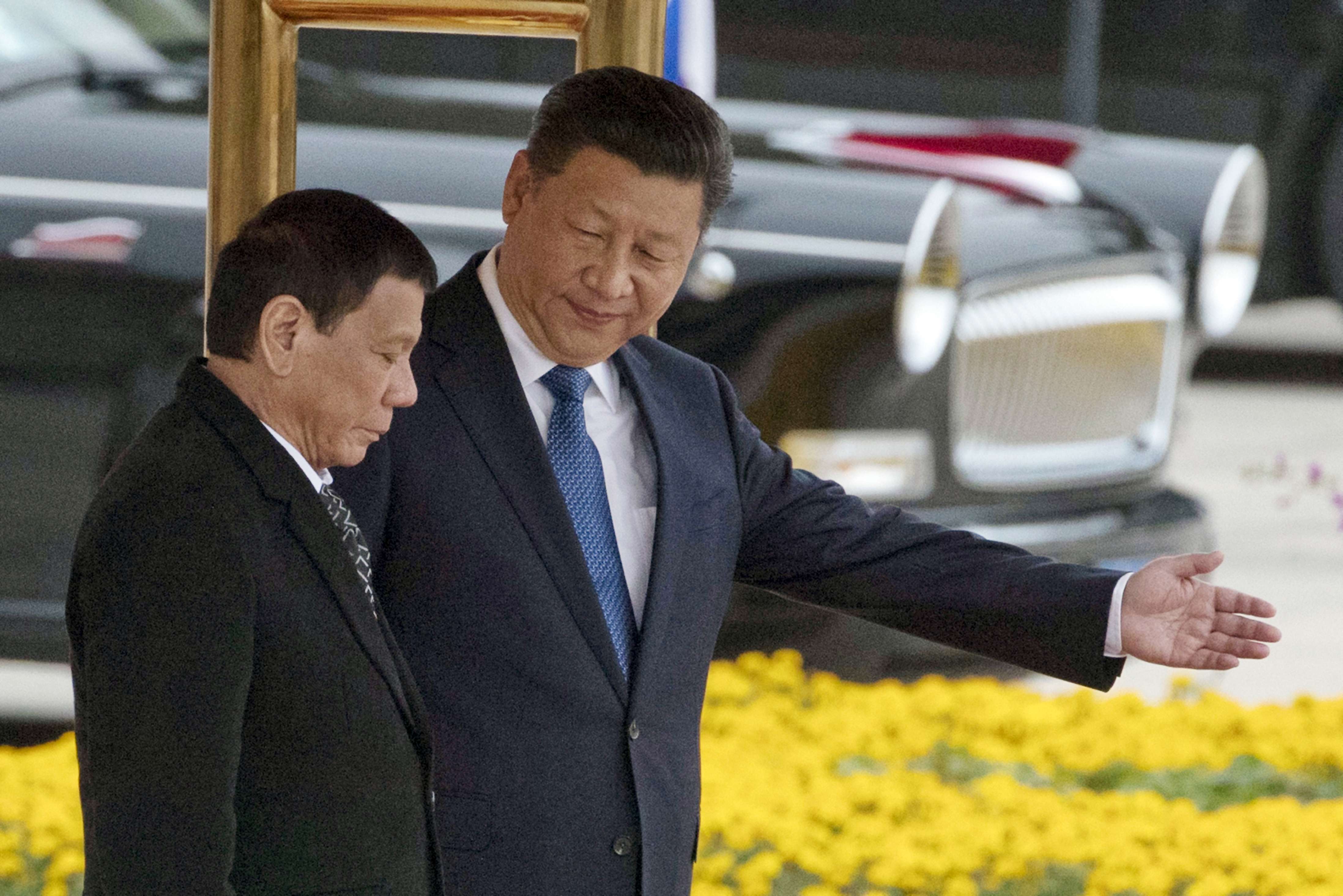 President Xi Jinping leads Philippine President Rodrigo Duterte during a welcome ceremony outside the Great Hall of the People in Beijing, last October 20. The question is whether other Asian countries traditionally allied with the US will also now tilt towards China. Photo: AP