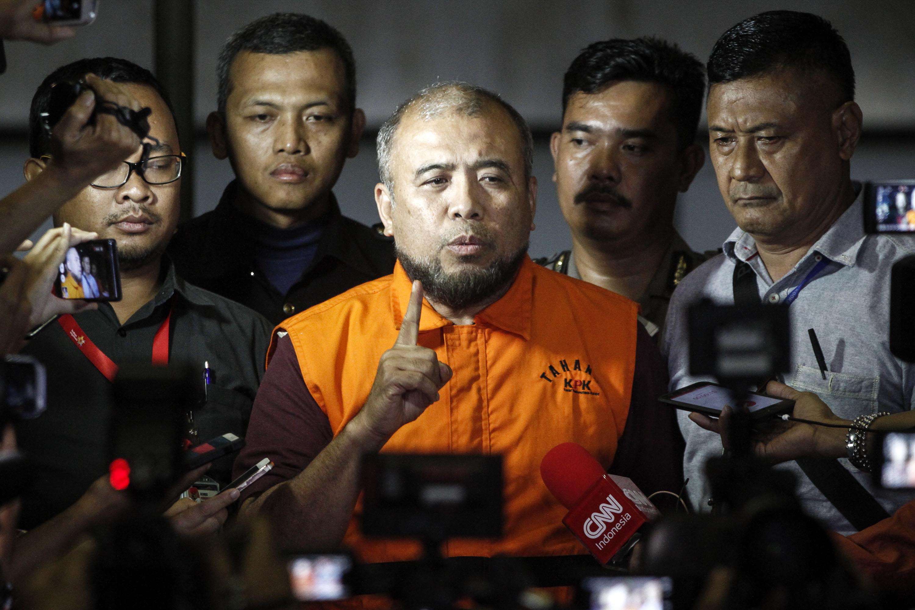 Patrialis Akbar, Indonesia’s former justice minister, speaks to the media after being detained for allegedly receiving bribes from a meat importer seeking to influence the Indonesian Constitutional Court. Photo: AFP