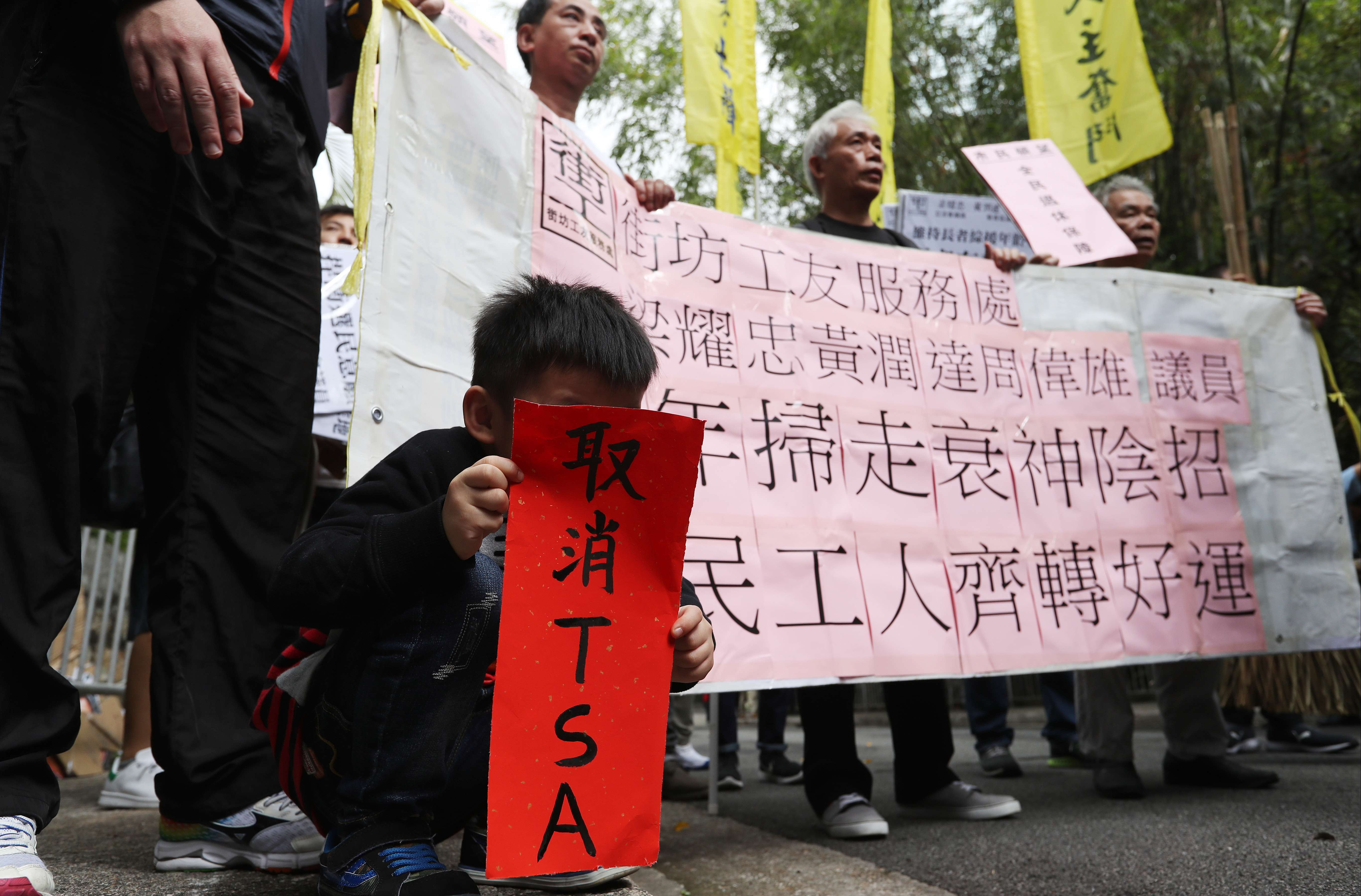 A young boy holds up a “fai chun” saying “cancel TSA”, at a protest against Chief Executive Leung Chun-ying’s performance, outside Government House on January 30. Photo: Nora Tam