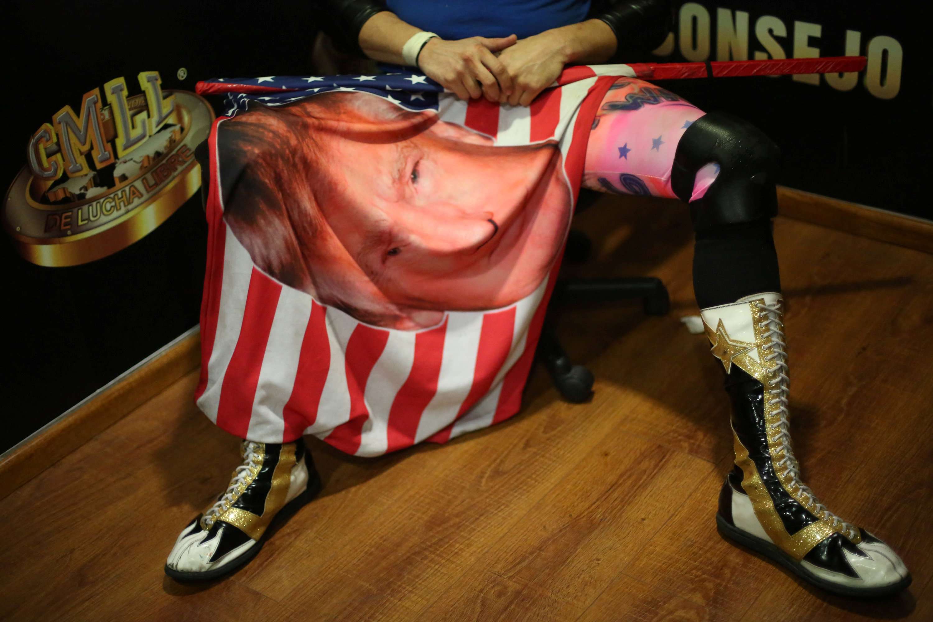 A US wrestler role-playing as a fan of President Donald Trump holds a flag with Trump's face during an interview, before a wrestling match in Mexico City on Sunday. Trump’s presidency could go into free fall if he does not secure some victories in the coming year. Populist voters are fickle. Photo: Reuters