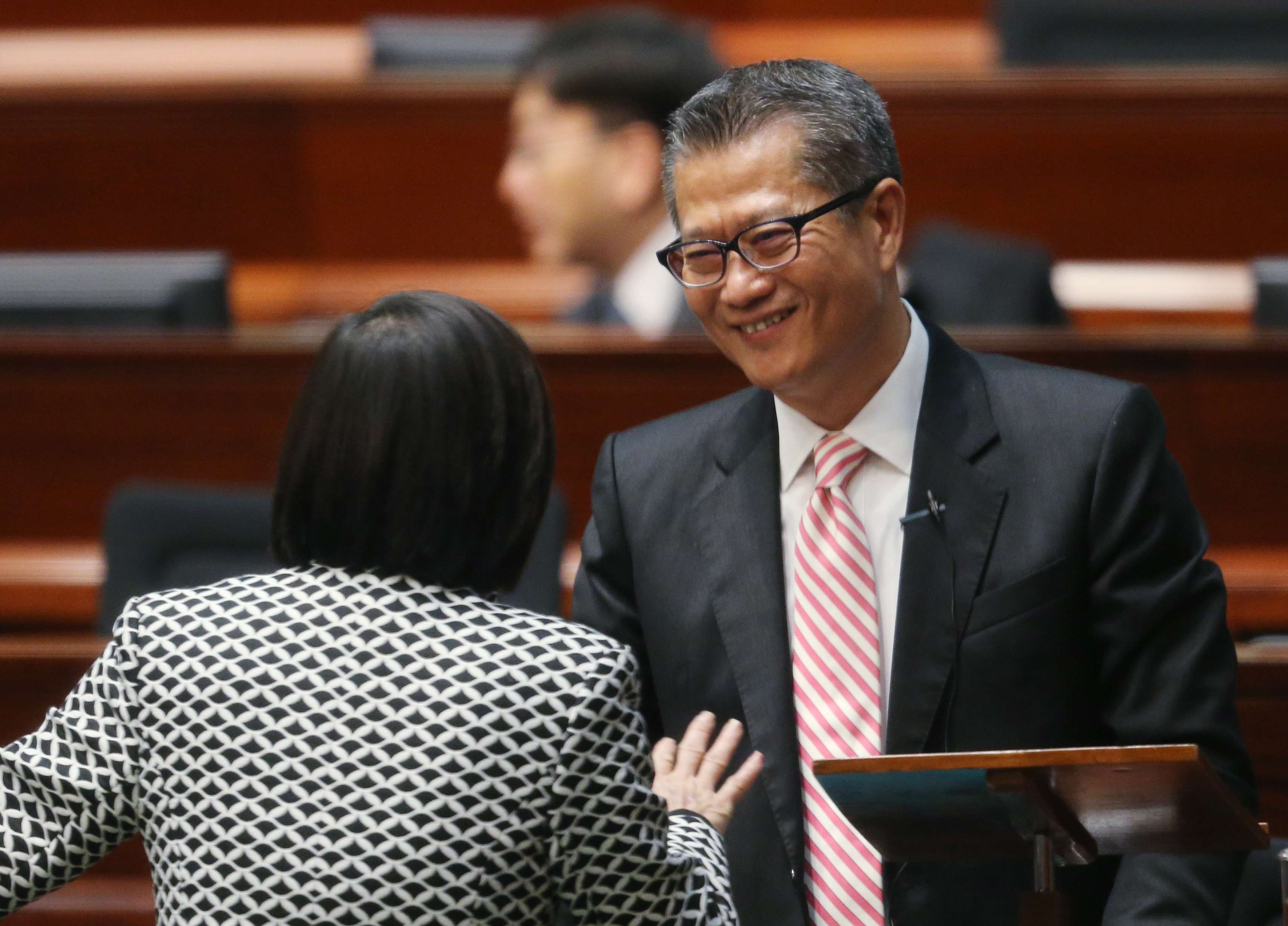 Financial Secretary Paul Chan has a quiet word before delivering his budget. Photo: Dickson Lee