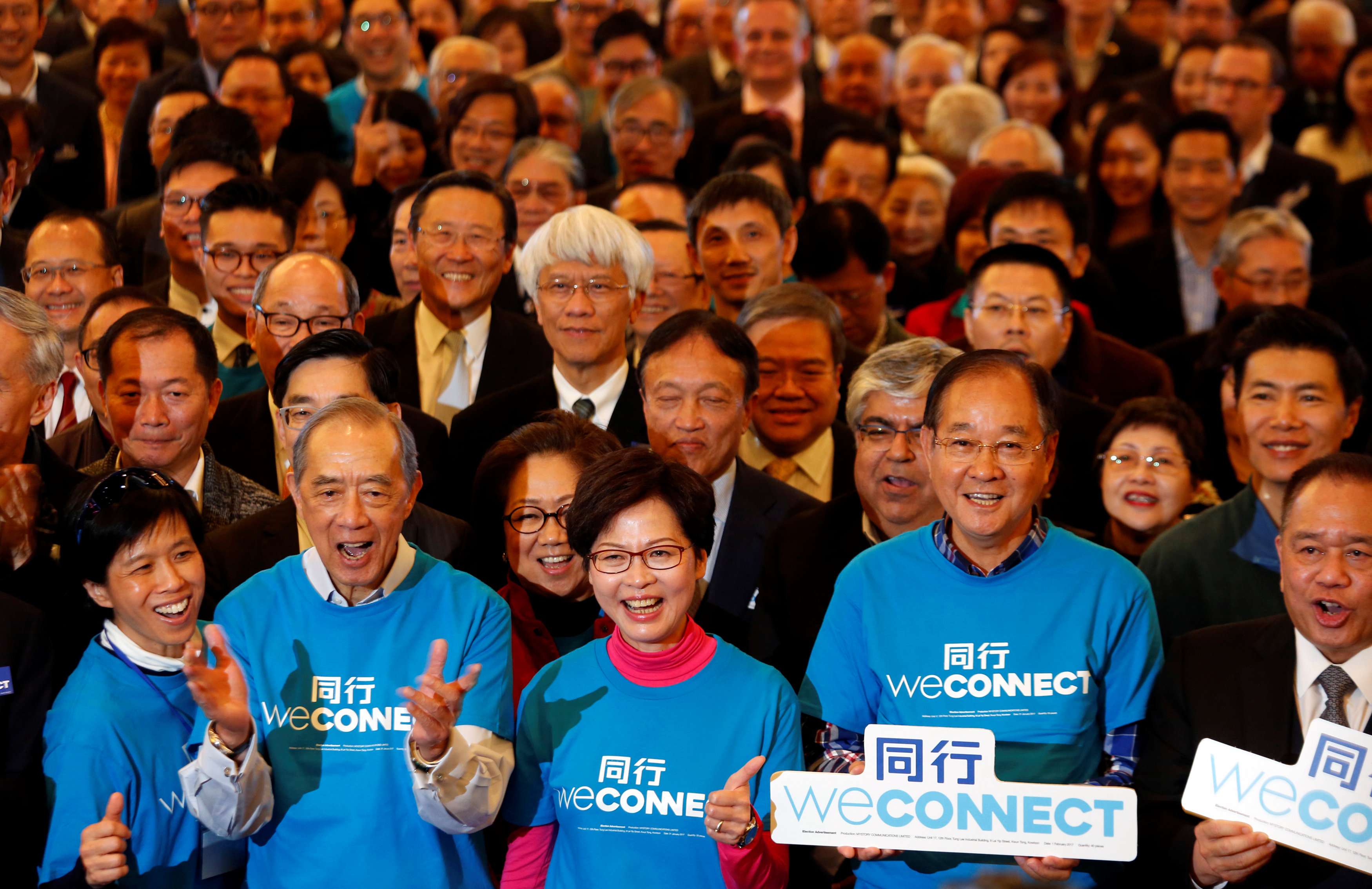 Chief executive contender Carrie Lam poses with her supporters during the launch of her campaign on February 3. Can her rich and powerful backers really help to bring about the “new style of government” she promises, solve housing problems and offer a “new vision”? Photo: Reuters