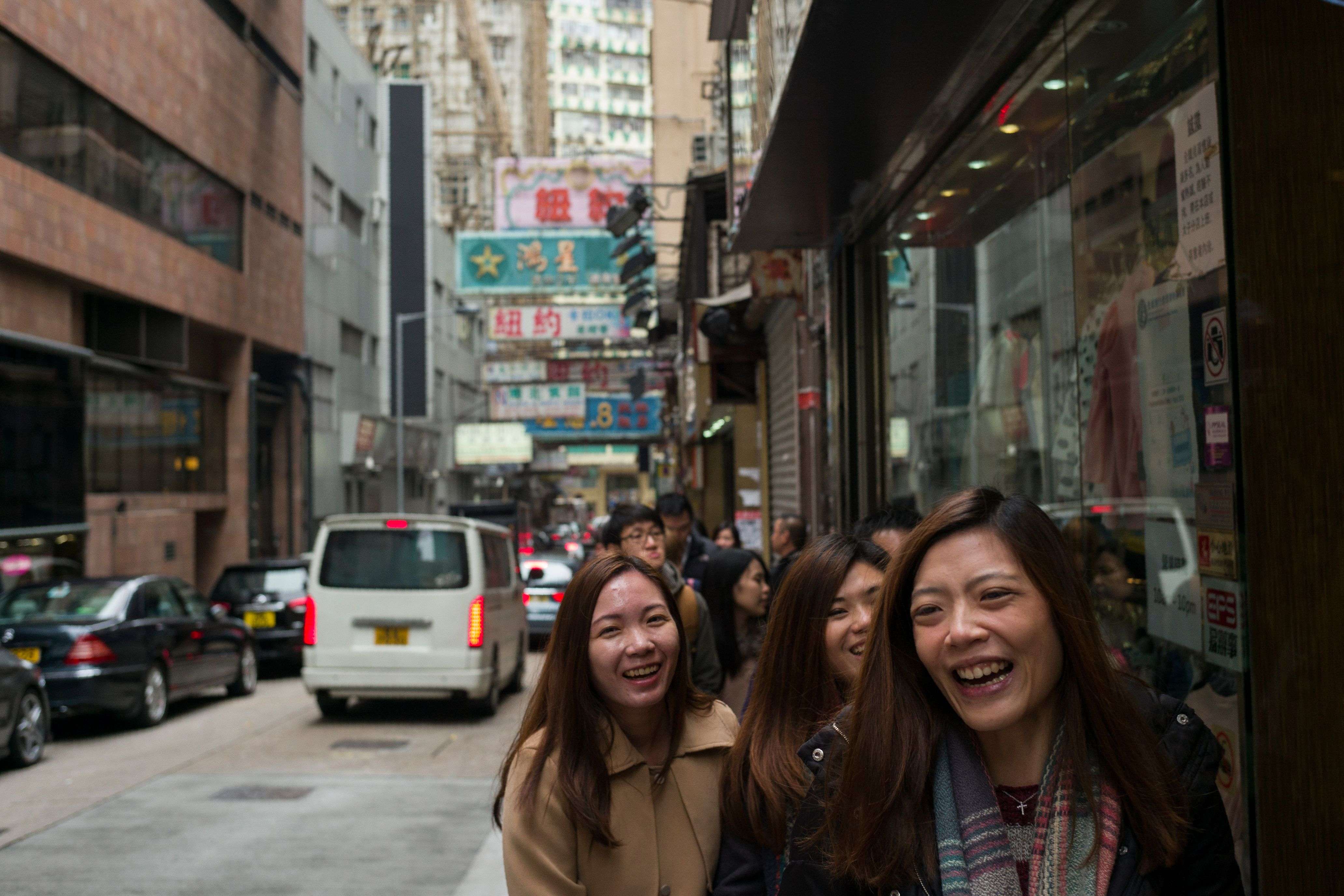 Pedestrians in Hong Kong share a laugh. Hong Kong has a role to play to help China to understand the world, Westernised and modern, and help the world understand and integrate with China. Photo: AFP