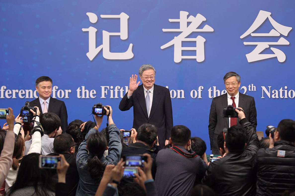 Zhou Xiaochuan (centre), governor of the People's Bank of China, speaks to the press at the media centre in Beijing on Friday morning. Photo: Simon Song